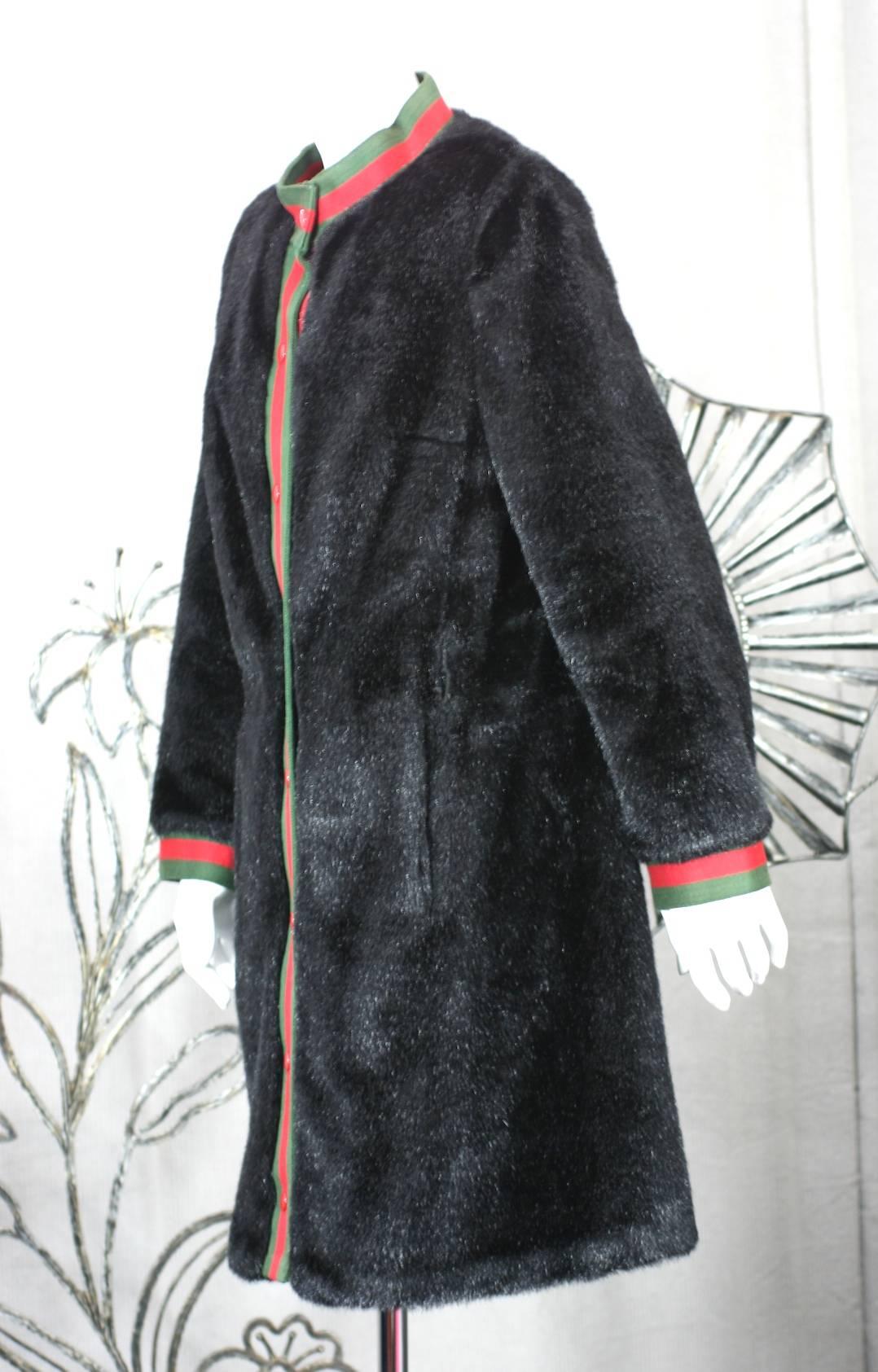Before Calvin Klein established himself as an American Modernist designer, his company produced coats on 7th Ave.
American manufacturers looked to Europe back in the day and this coat is obviously influenced by Gucci. 
This Calvin Klein faux seal
