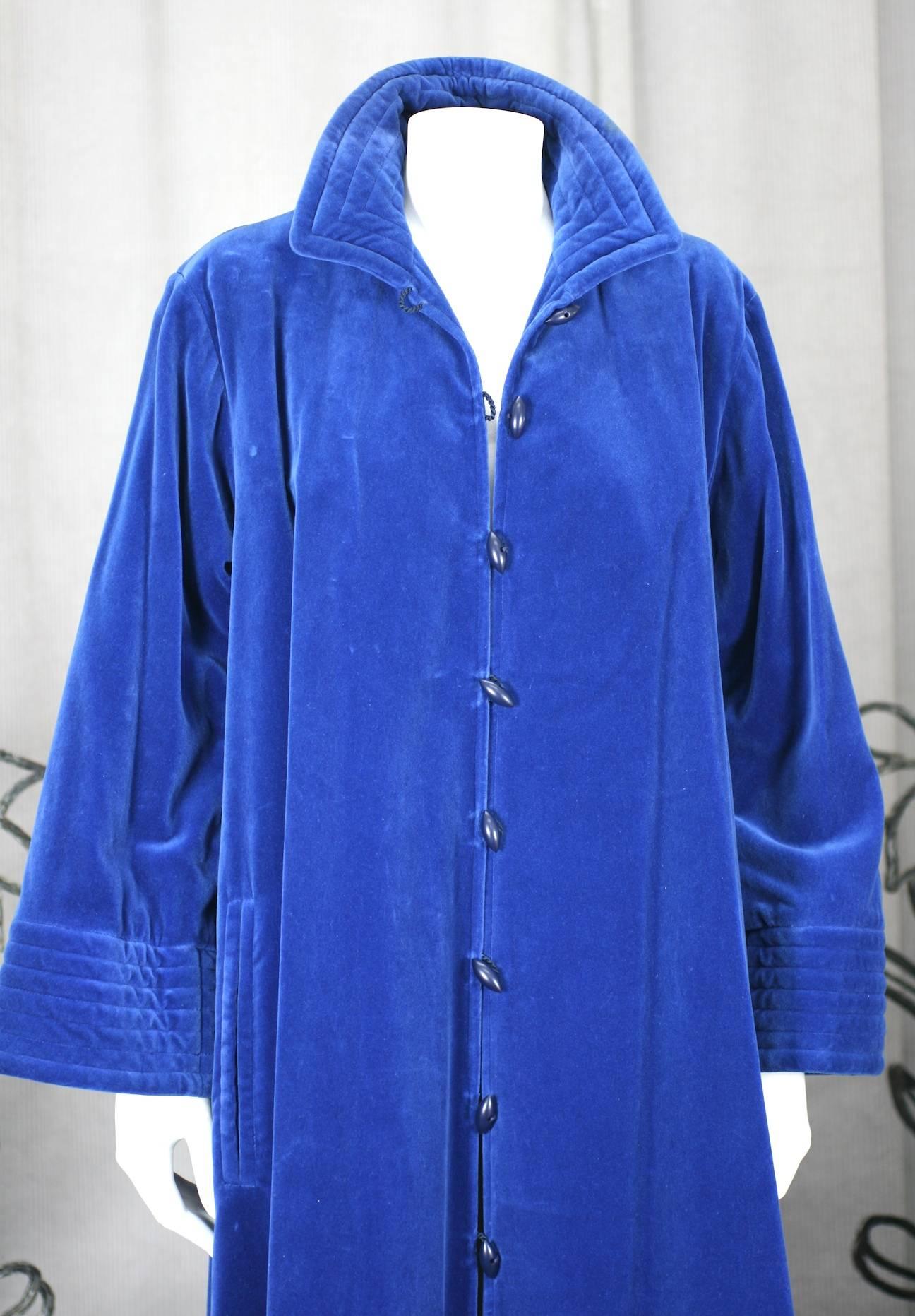 Yves Saint Laurent Rive Gauche corn flower blue cotton velvet long, flared coat. Chinese inspired trapunto stitching with quilted collar and cuffs. Slash pockets and unusual toggle fasteners shaped like small pods. 1980's .France Excellent