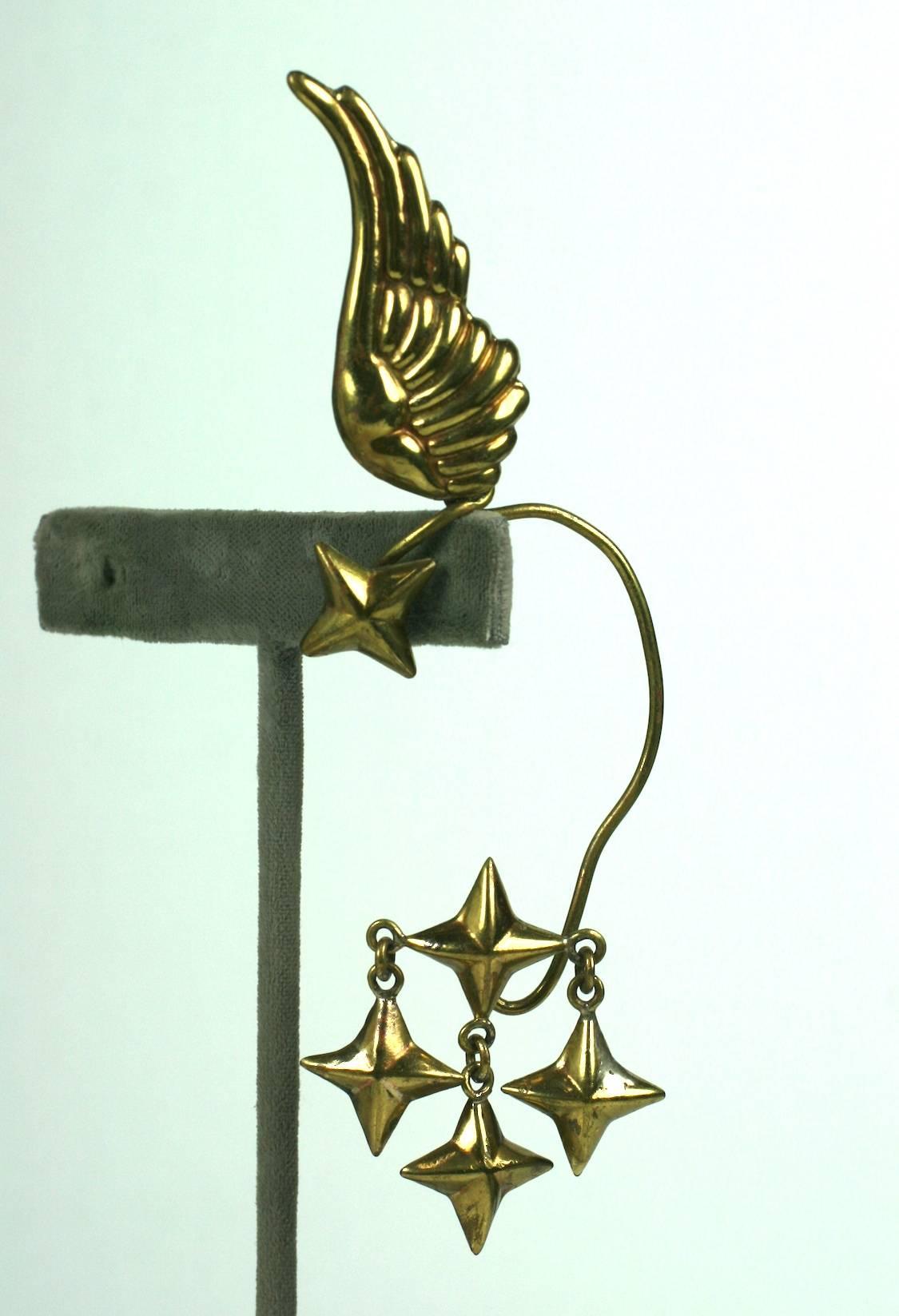 Hubert Harmon winged star drop earrings, designed to be worn over the ear. The repousse wing sprouts from the top of your ear while the star pendants dangle below.
Rare to find work by this Taxco metal smith who worked in Europe (Schiaparelli)
