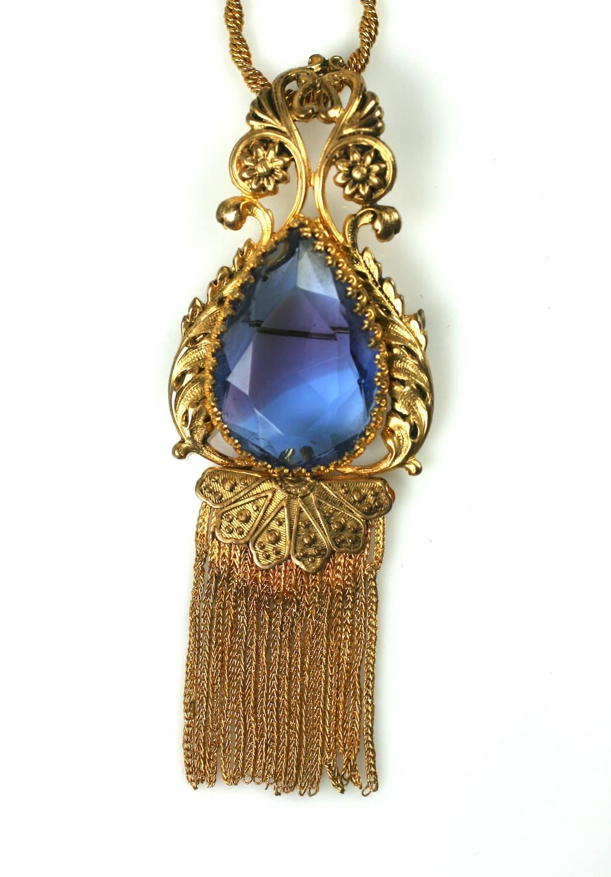 Christian Dior Haute Couture pendant brooch necklace.The large pear shaped faceted faux sapphire with central amythest zone is set in gilt filigree with fringed chain tassels. The detachable twisted gilt rope chain necklace marked France on the hook