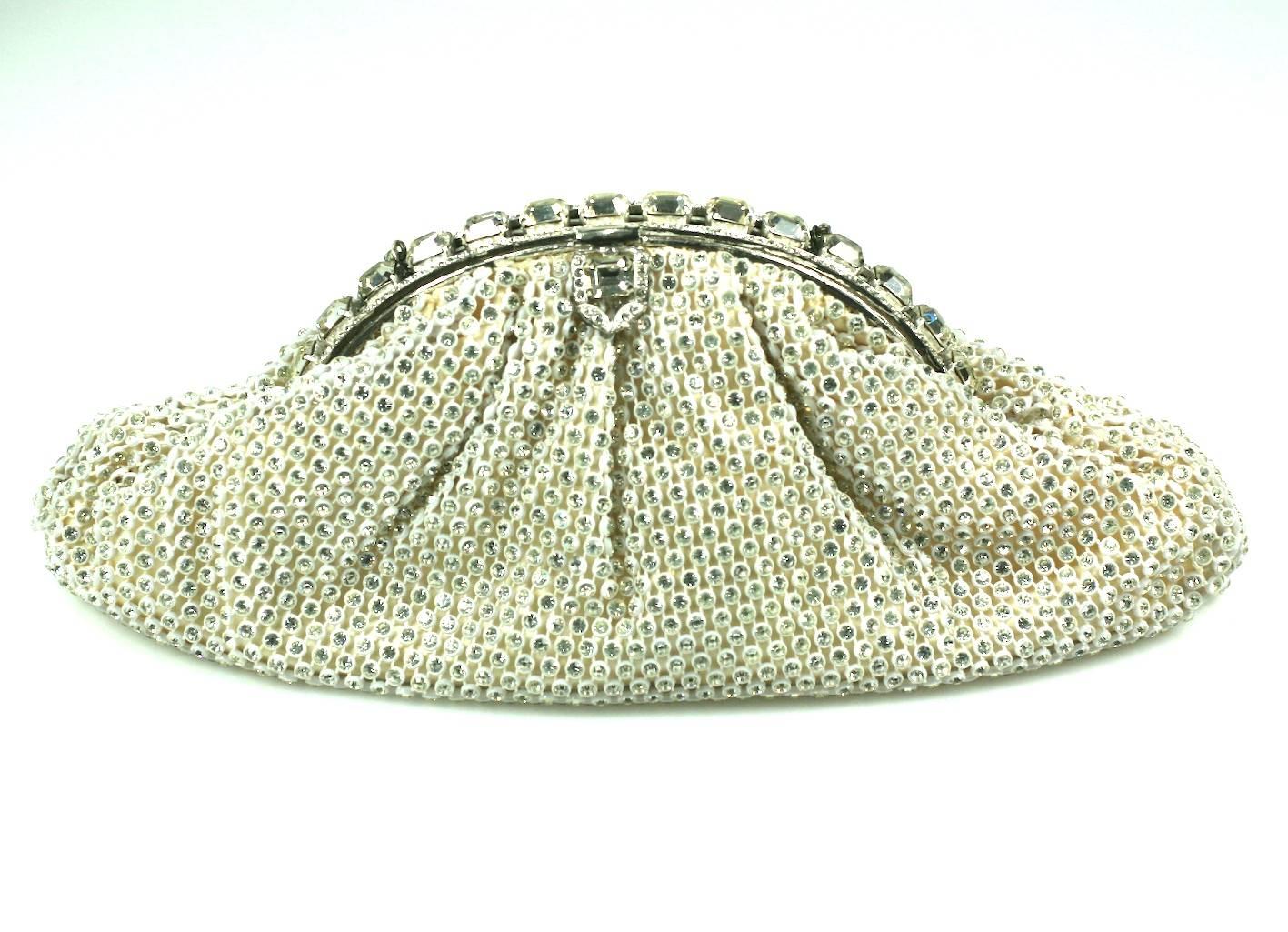 Elegant Pave Rhinestone Studded Evening Bag retailed by Neiman Marcus. Body of bag is made of a plasticized mesh which is embedded with Swarovski crystal rhinestones. The frame is composed of large, sparkly emerald cut crystals across the top.