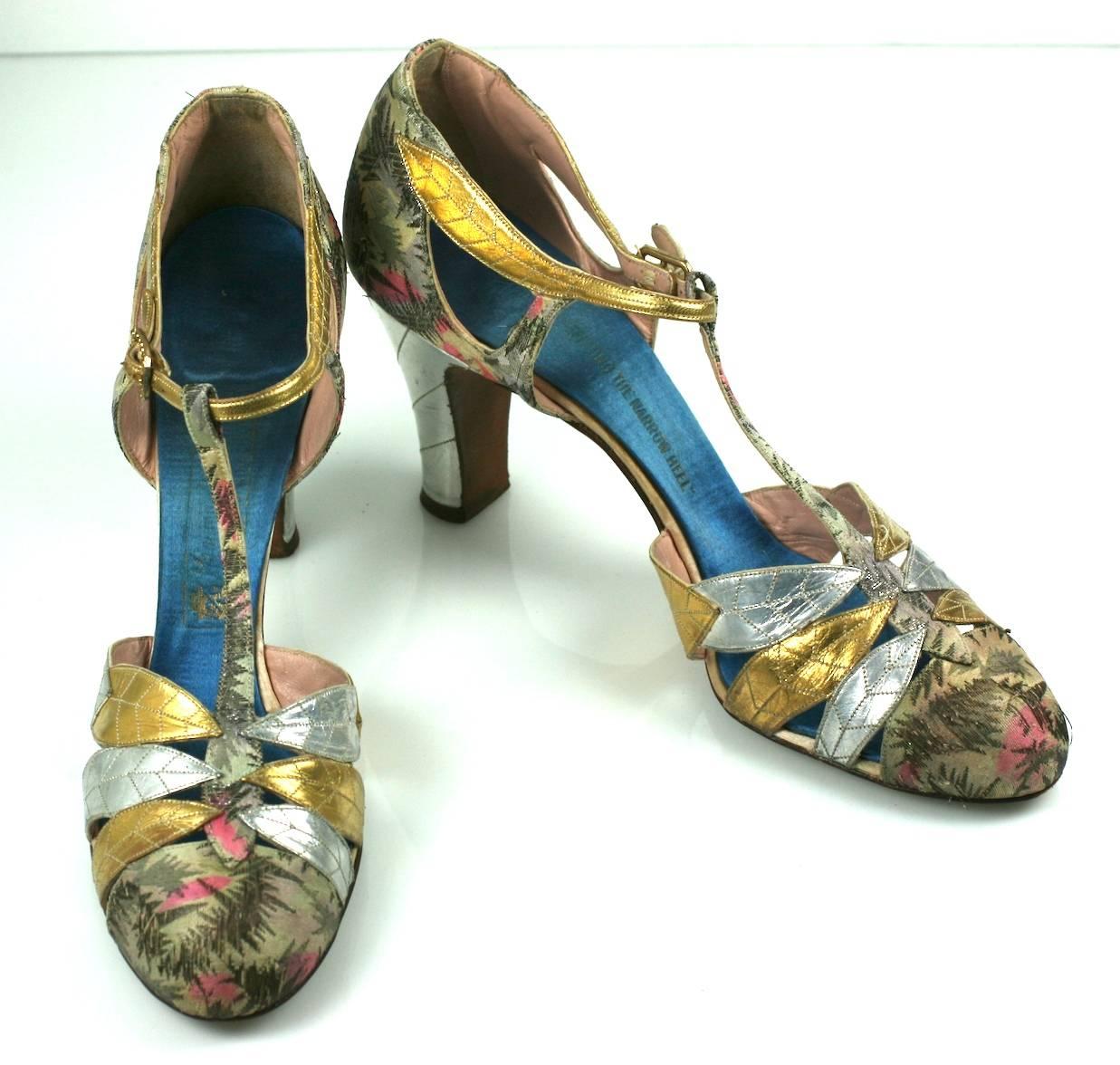 Art Deco Lame and Gilt Kid Evening Shoes, 1920's. Gold and silver kid leather leaf motifs are applied over metallic lame with top stitched silver kid heels . 
Length from toe to back of heel (not sole measurement). 8.5