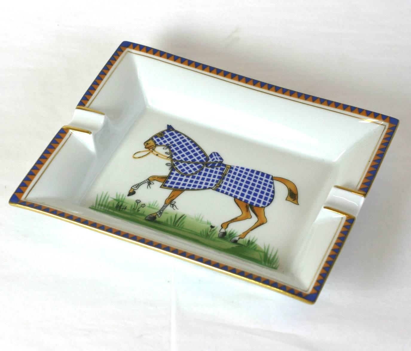 Hermes ashtray or catch all dish decorated with blue check blanketed horse, hand painted on Limoges porcelain. Suede base lining. 2000's France. 
Excellent condition.  