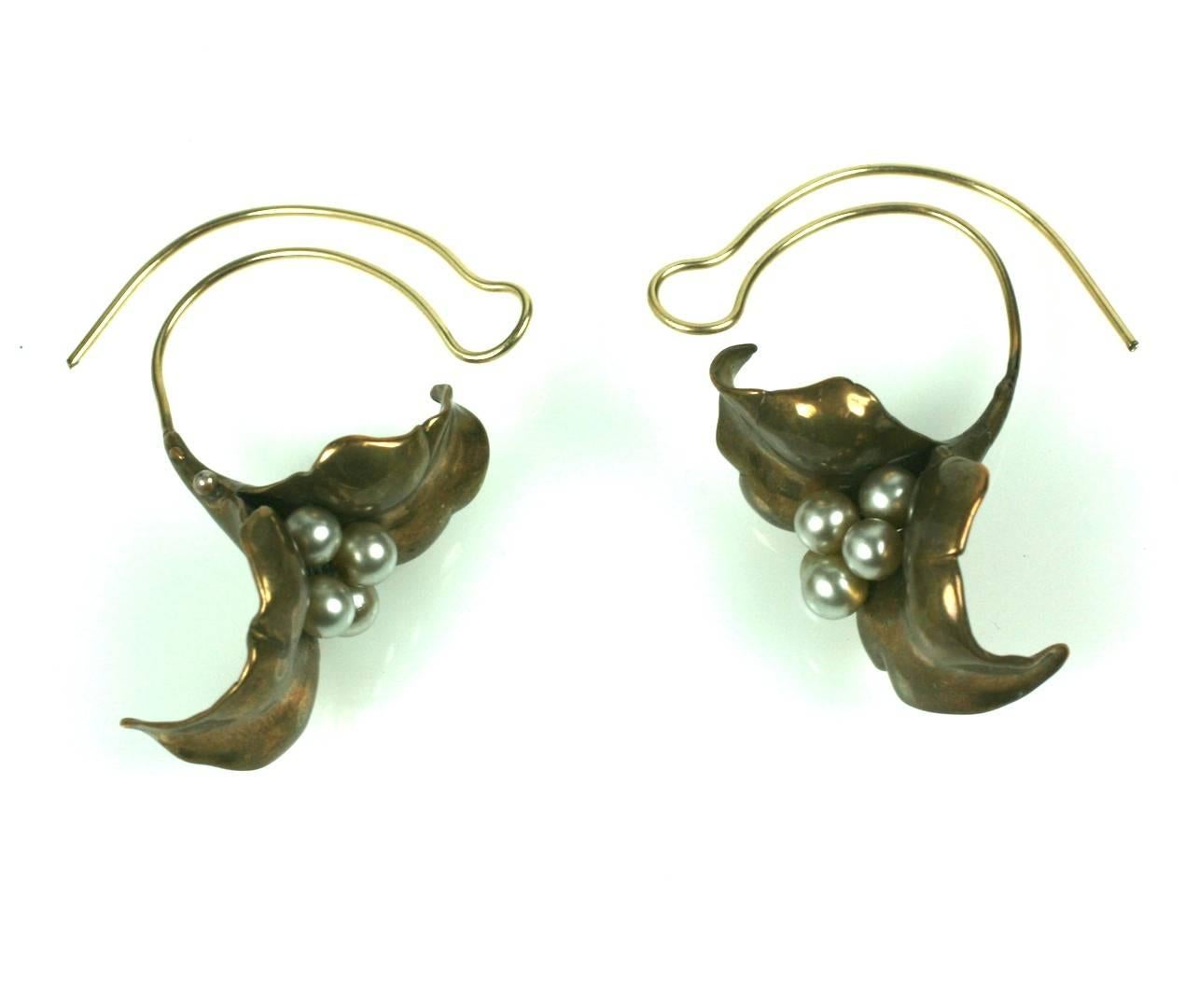 Unusual Artisan Cala Lily Earrings with faux glass pearls. The flowers hang low below the lobes and the ear wires are quite unusual as they mimic the curve of the flower stem. Handmade in brass and extremely graphic in form. Flower head measures