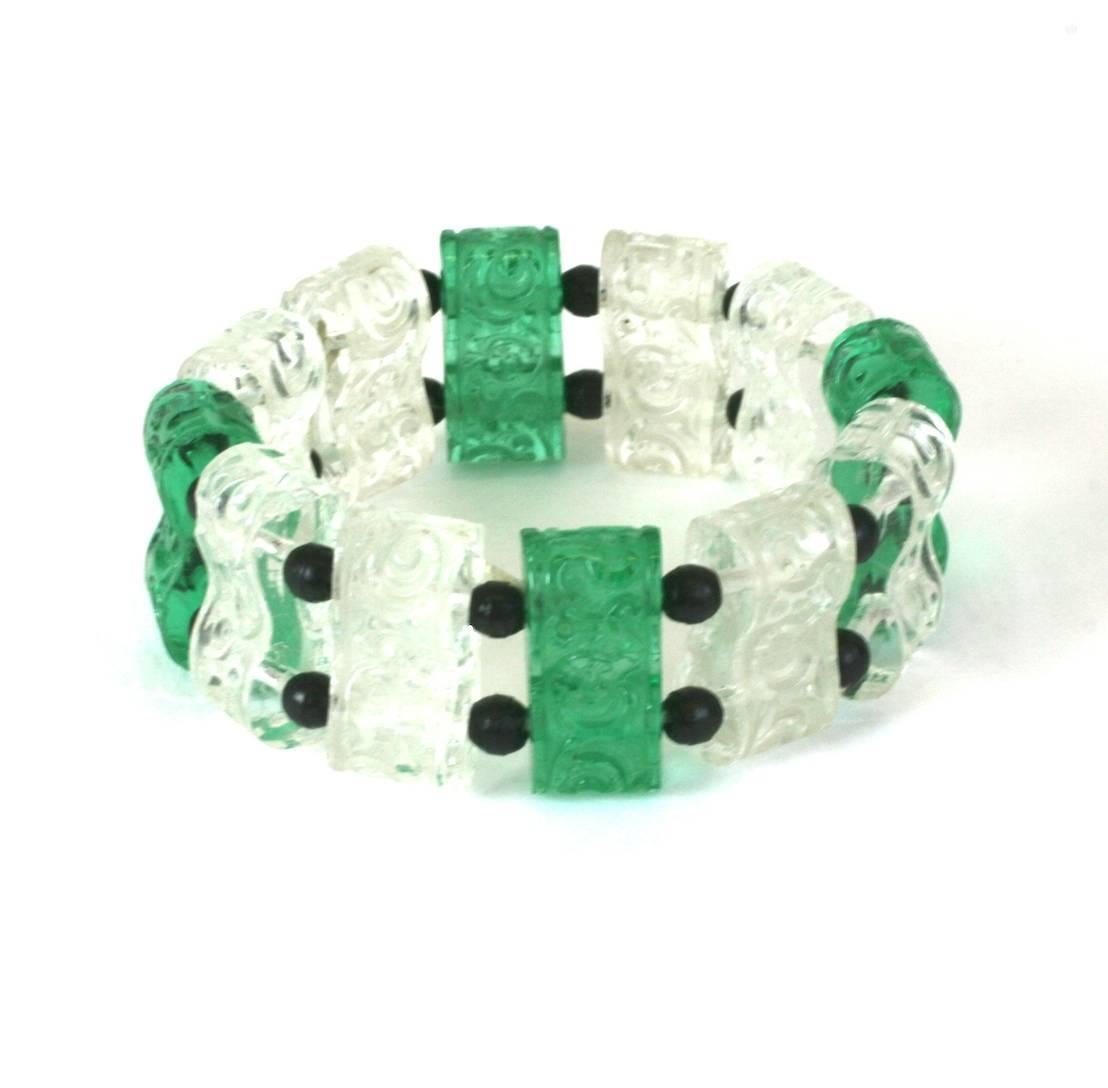 Art Deco Glass  Stretch Bracelet, French 1920's of etched crystal and emerald foliate patterned links on elasticized  cord. Further accented by black glass round bead spacers. Excellent Condition
High 1