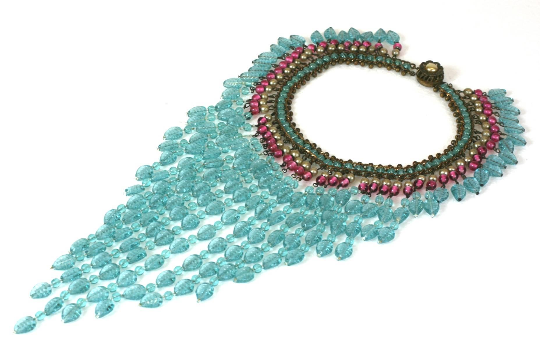Early Miriam Haskell Bib Necklace in the Indian style, popular in the late 1930's, composed of faux pearls, pate de verre ruby beads, and faux carved   and incised leaf shaped faux aquamarines.
Unsigned, as many of the early 1930's pieces