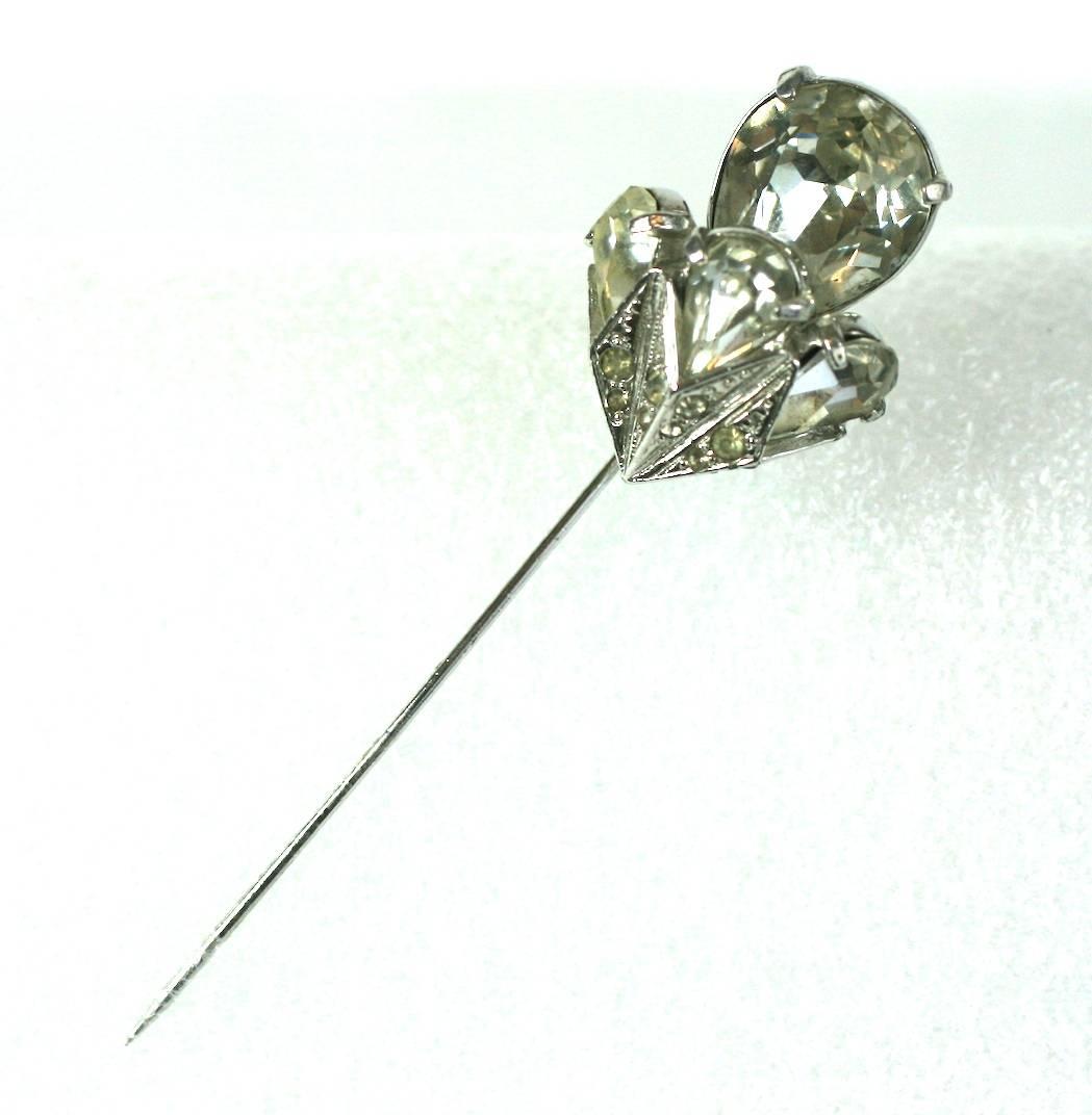 Eisenberg's striking, crystal paste stick pin set in silvered metal with a large pear shaped stone surrounded by a border of 3 smaller pear cut stones in pave settings. Set with bright, sparkling stones, as Eisenberg is known for. 3.5