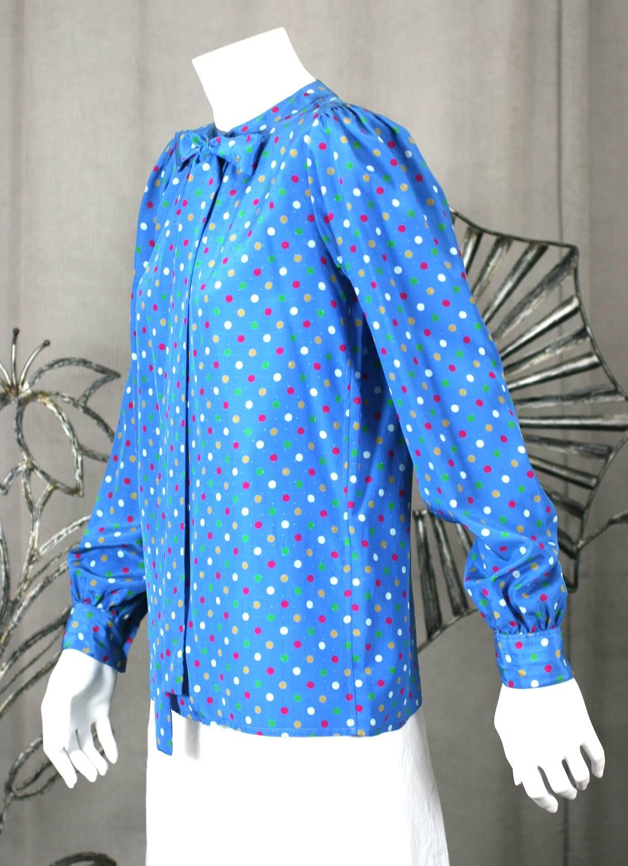 Yves Saint Laurent Polka Dot Bow Blouse with many transformative options. Can be worn tied or open with streamers hanging for a more relaxed look. 
One button at neck with deep, subversive, front slit below. Size 34, France 1970's. Excellent
