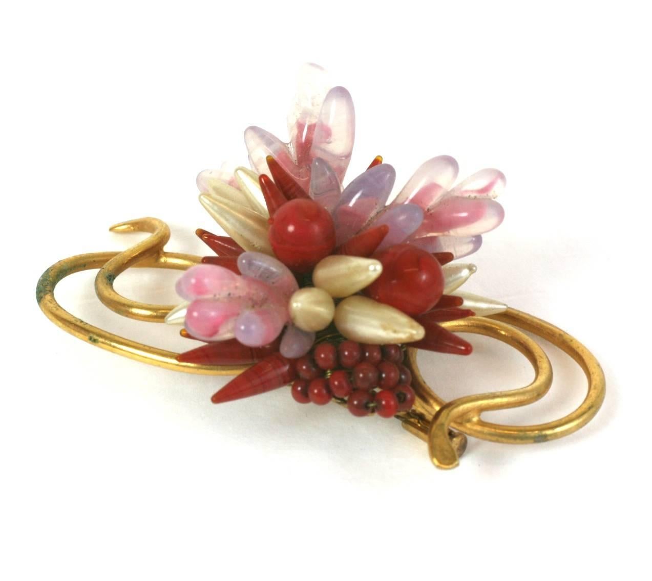 Ruby and Pink Pate de Verre Brooch by Louis Rousselet. Handmade poured glass petals in various forms and colors are wired onto a backing to form the central cluster. Gilt wire work emanates from the center. 2.75