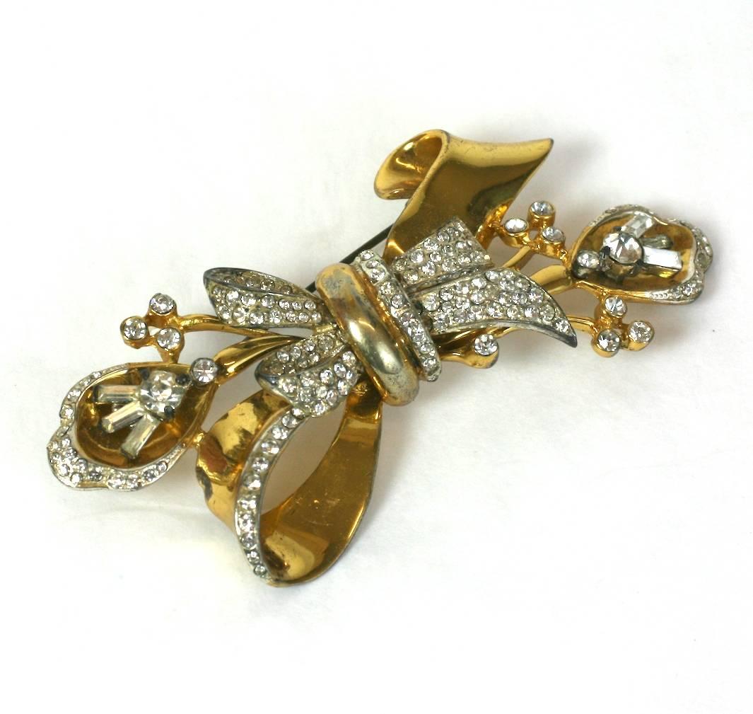 Large Corocraft Retro sterling silver stylized bow knot and lily brooch. Gold washed in a bright yellow gold finish and highlighted with crystal pave and vari cut rounds and baguettes. High quality construction. 1940's USA.  Excellent Condition. 
