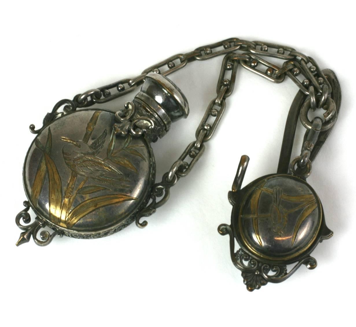 Victorian Perfume Chatelaine in the Japanesque taste, popular in the late 19th Century. Silver plated with partial gilding as highlighting for the Aesthetic style bird and butterfly motifs. The perfume bottle hangs from the chatelaine and has a