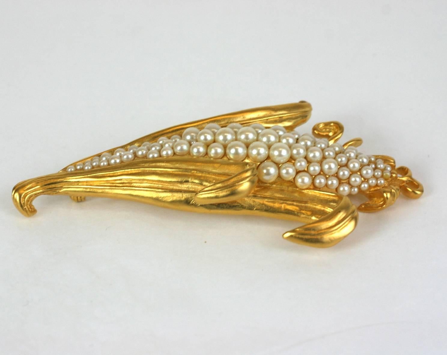 Karl Lagerfeld Pearl Corn Brooch from the 1980's. Large scale brooch with graduated glass pearls. 1980's France. Matte gold finish. Excellent condition. 
4