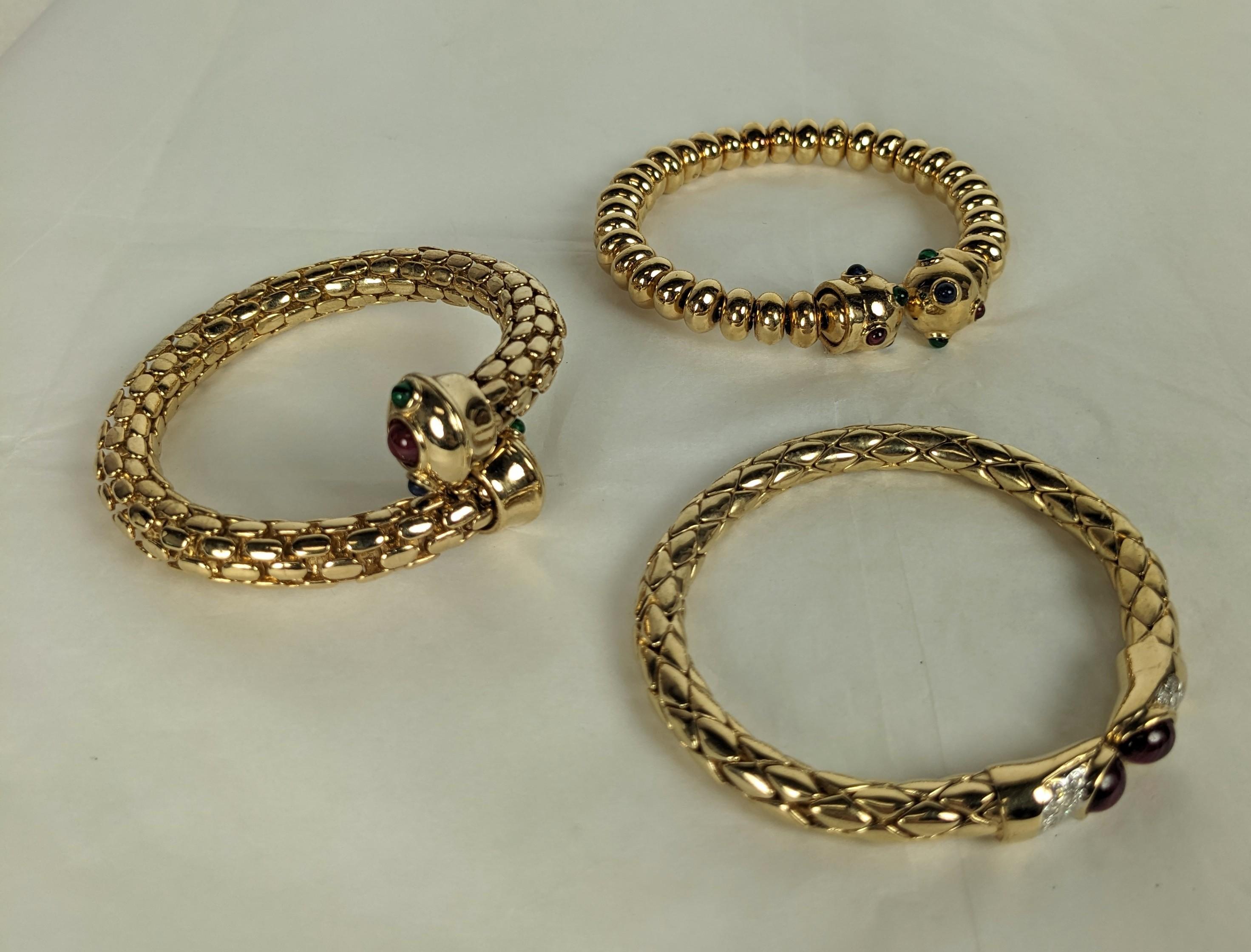 Bulgari Style Gilt Pave Gem Bangle from the 1990's Italy. One has ruby glass terminals, the other 2 have ball terminals with faux gem stones. 3 variations available, high quality, unworn old stock. 1990's Italy.