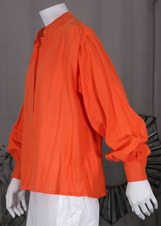 Yves Saint Laurent's chic version of the french painters smock in brightly colored openweave orange cotton muslin with button front placket and large balloon sleeves. 1970's France. Chic and timeless. Excellent condition.
Vintage size 38.
Length