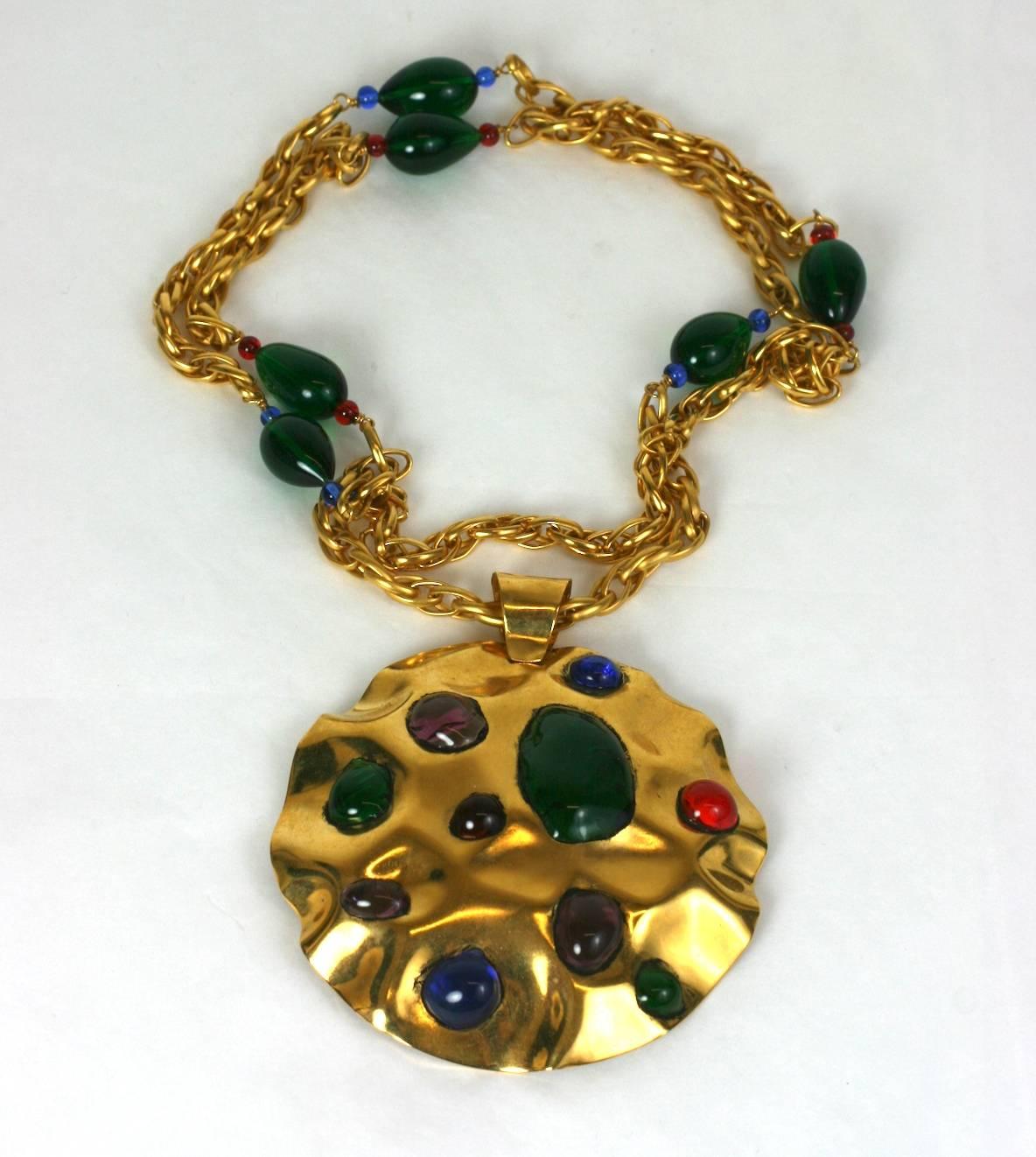 Yves Saint Laurent Haute Couture 1980s Berber inspired gilt, hammered pendant necklace.
Haute Couture Unsigned, Made by hand by Maison Goossens with poured glass multi colored cabochons. Wonderful large scale. Poured glass beads in coordinating