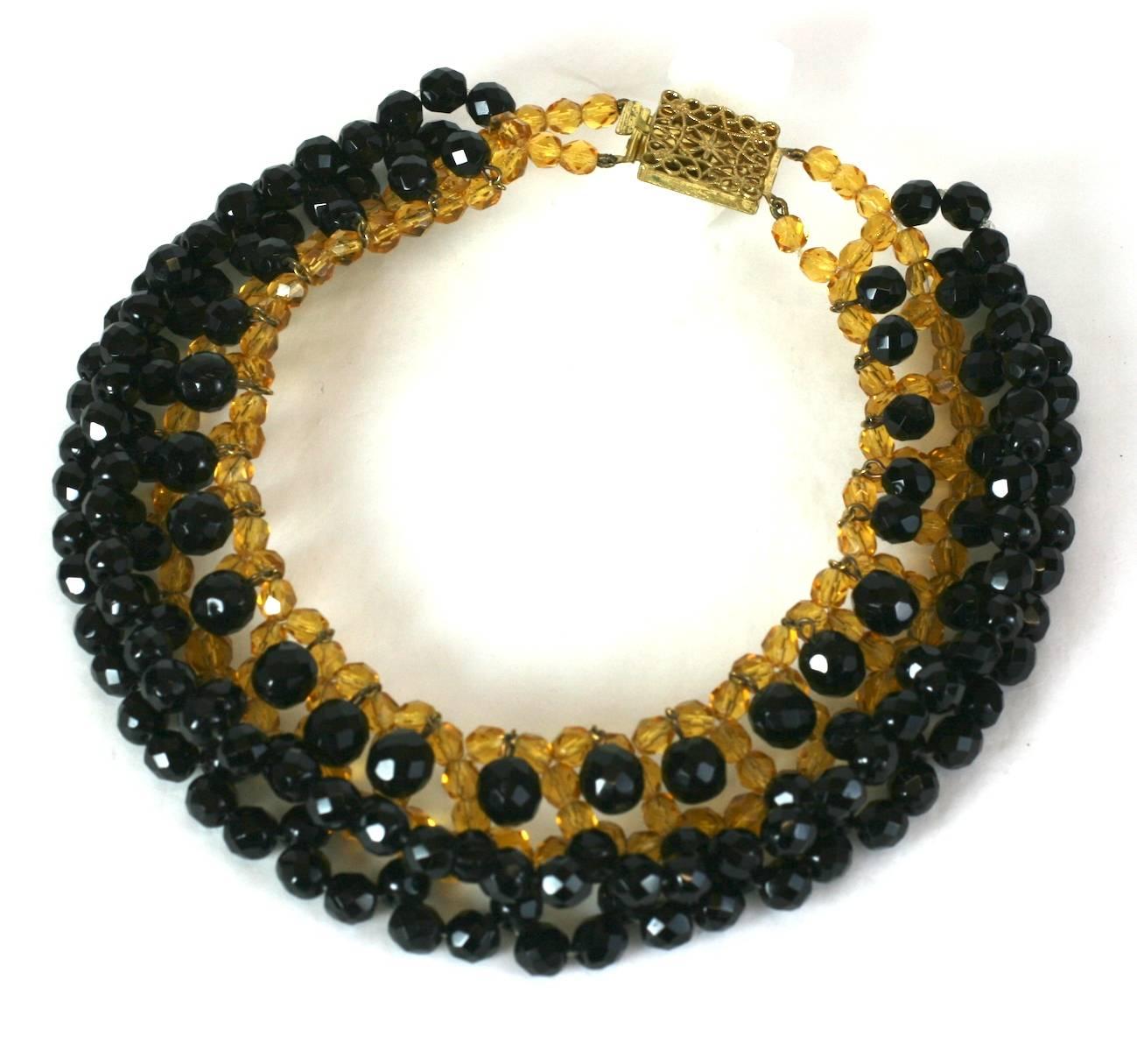Elaborate Citrine and Jet Couture Collar of French origin from the 1950's. The hand woven base collar is composed of faux citrine beads, with an edging of of woven jets. Close to the neck, faceted jet beads hang loose and move with wearer.