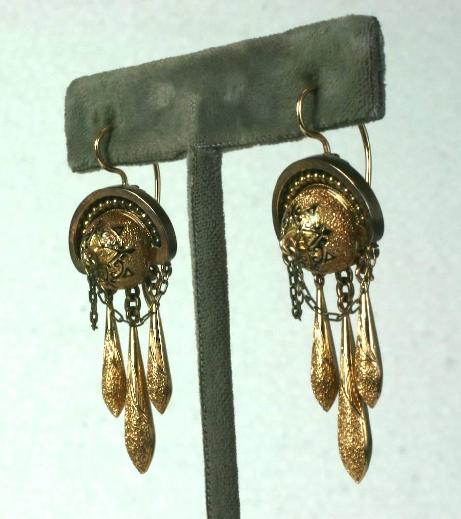 Elegant Victorian Drop Earrings with black enamel tracery. Each earring has 3 textured drops falling from a half ball motif with enamel decoration and swag chaining. 
High quality gauge 14k gold with original hinged ear wires intact.
1880's USA. 