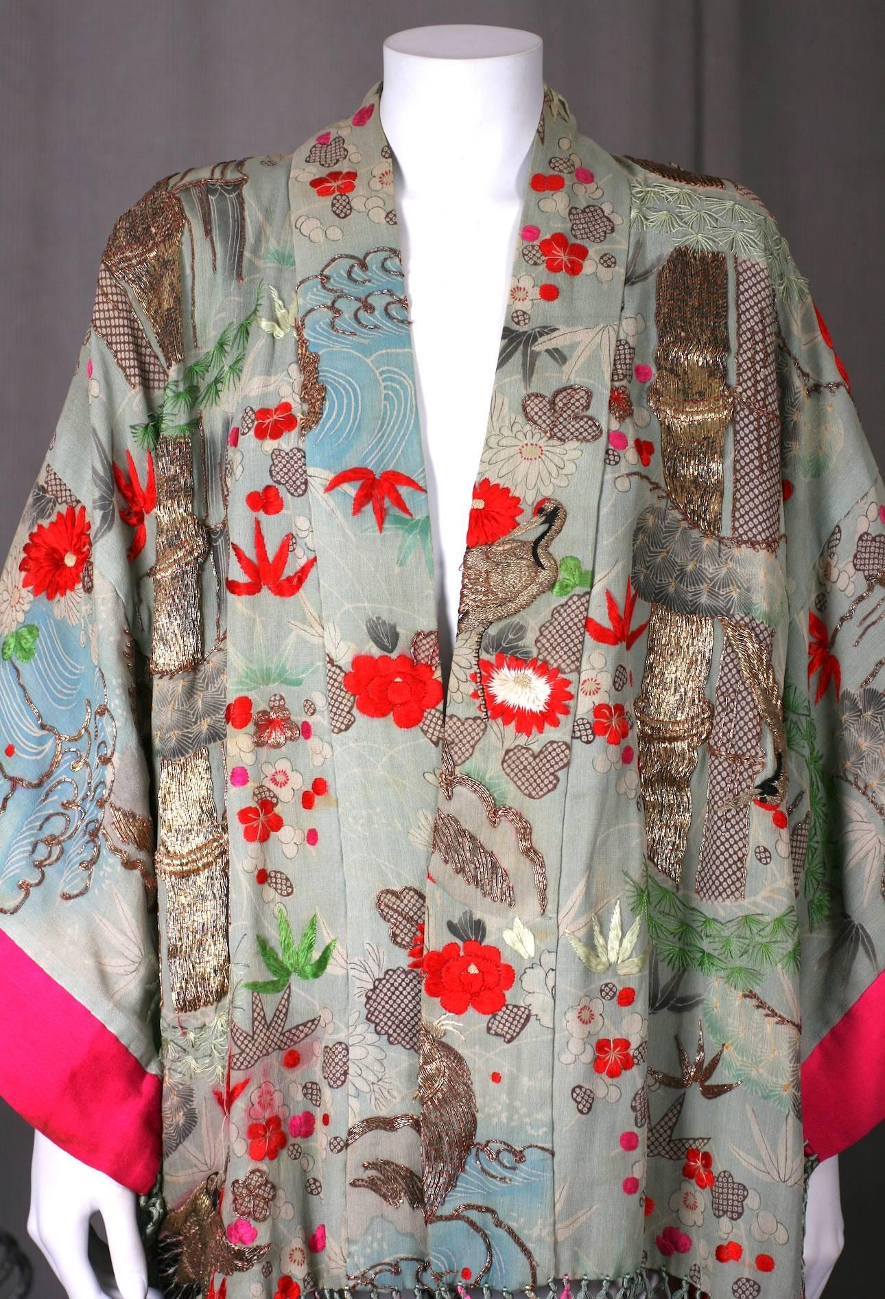 Elaborately embroidered and fringed Kimono from the 1920's, Japan. The silk scenic base of the kimono is re-embroidered with gold couched threads and multicolored silk threads, Turtles, herons, fish and other creatures are hand embroidered onto the