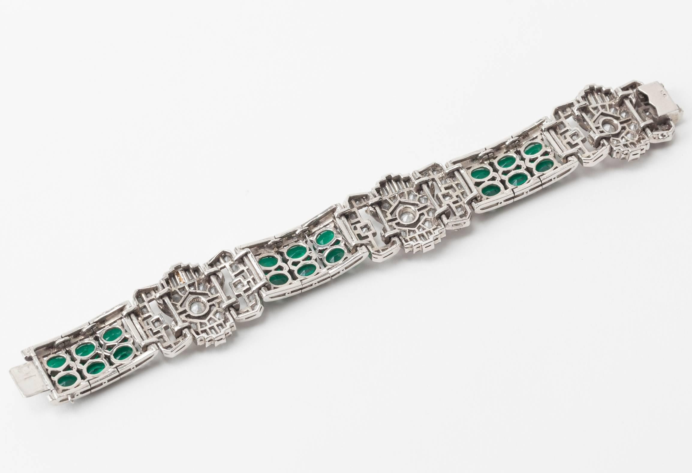 French Art Deco faux emerald paste bracelet from the 1920's. Beautifully crafted with 3 alternating stations of pave and baguette crystal links and oval faux emeralds. HIgh Art Deco styling and articulated construction. French silver hallmarks.