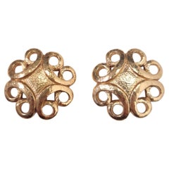 Yves Saint Laurent clip-on earrings in vintage gold-tone metal from the 1980s