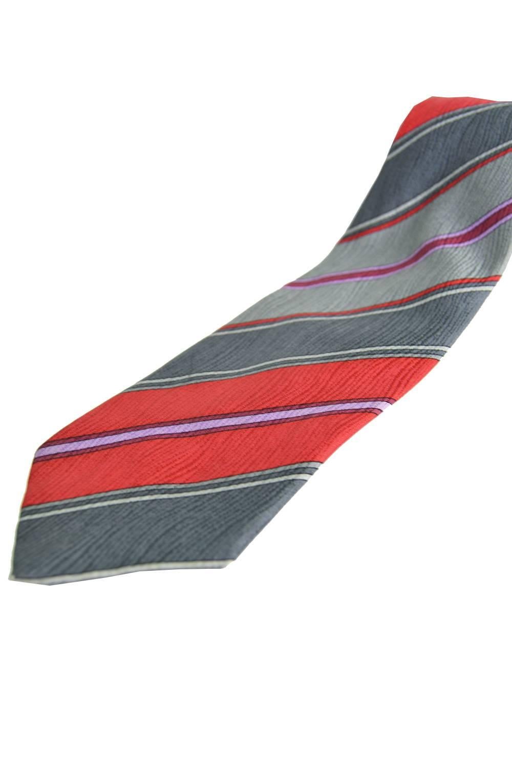 An elegant vintage mens necktie in a pure silk with a satin jacquard throughout by French luxury designer, Pierre Balmain. So timeless with the main colours being a classic red and grey with purple stripes throughout, it would make the perfect gift