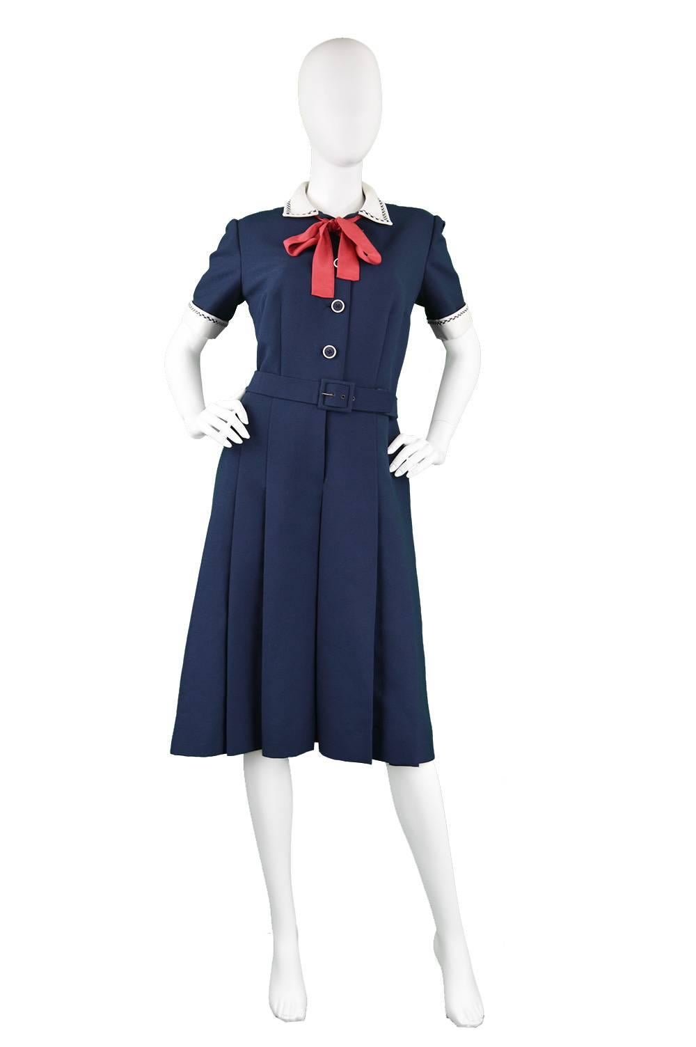 An incredible vintage nautical vintage dress from the 1960s by legendary designer label, Christian Dior during Marc Bohan's reign as creative director. In a classic navy blue with a white collar and cuffs with a contrasting bright red pussybow