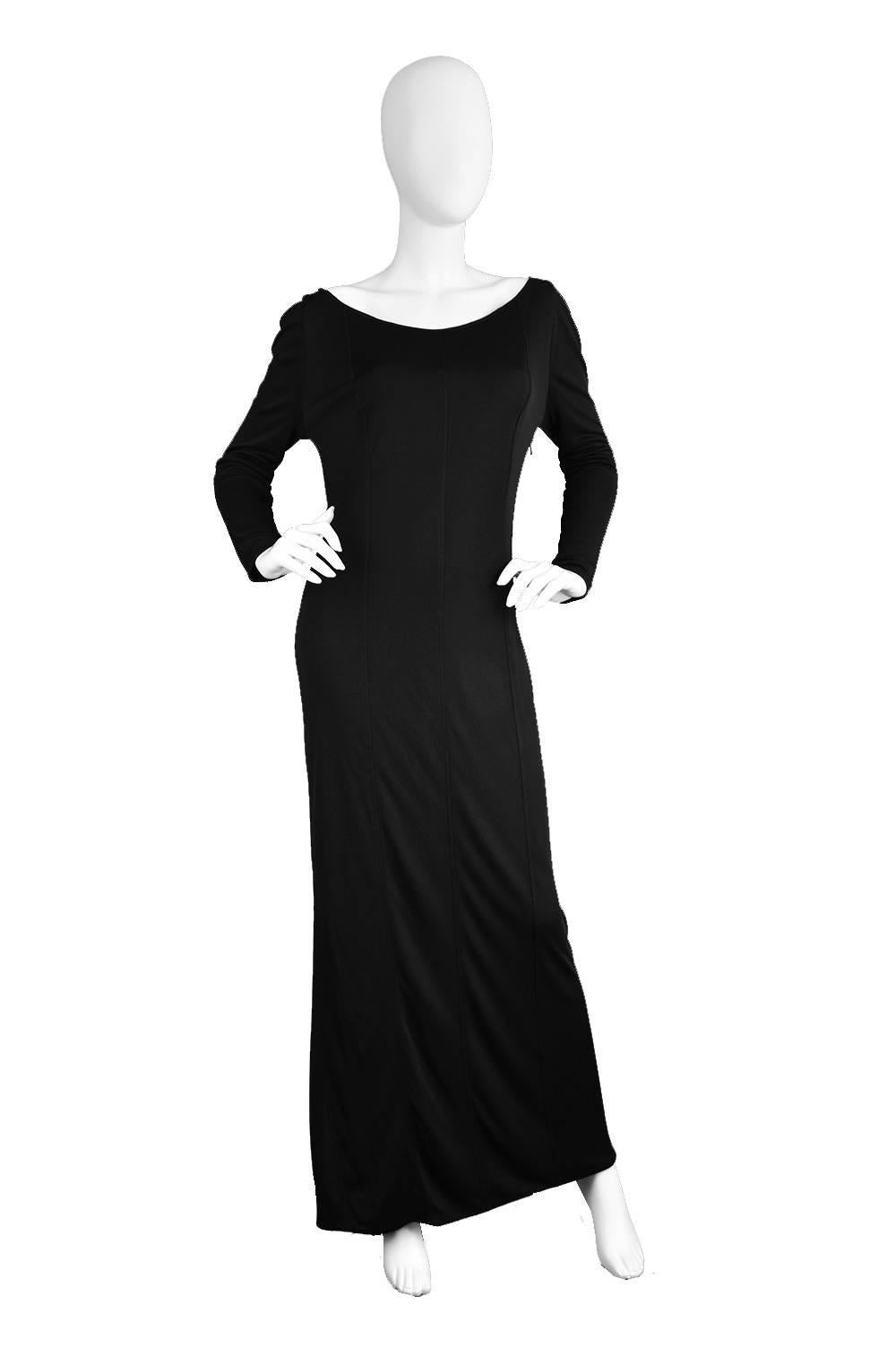 An incredibly elegant vintage evening gown from the 1970s by Yuki of London, from his higher end own label, before he started working with the lower priced line at Rembrandt. This stunning dress has a scoop neck that flaunts the sensual décolletage