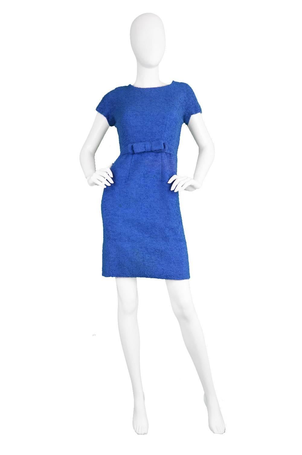 An incredibly chic vintage wiggle dress from the 1960s by legendary, luxury French designer, Jacques Heim for I.Magnin. In a sumptuous, thick blue boucle wool fabric with a flattering, wiggle cut which is nipped at the waist, fitted round the hips