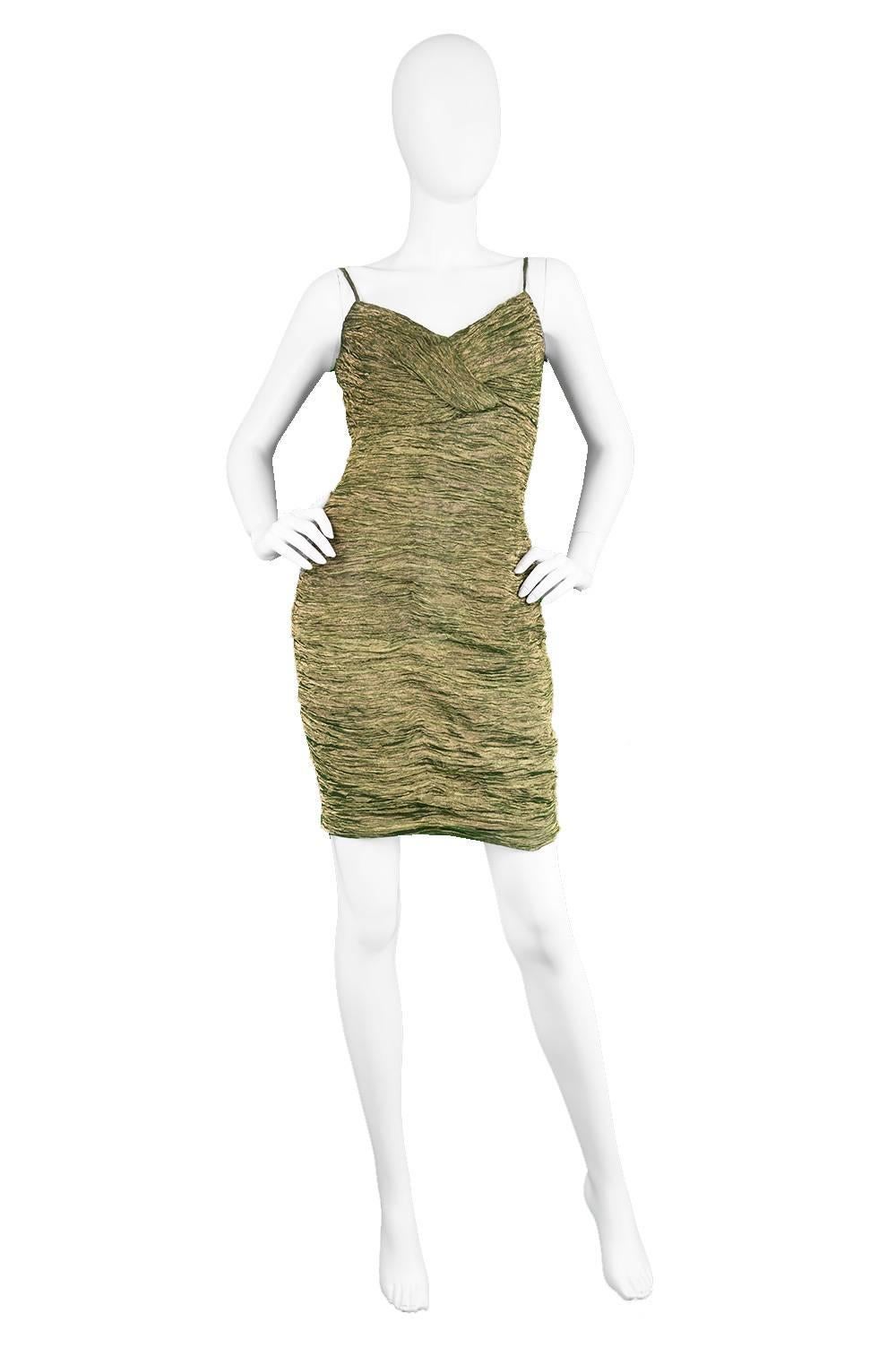 A luxurious and sexy vintage party dress from the 1980s by little-known but genius vintage designer, Marc Kehnen. In an incredibly expensive looking and feeling, ruched/textured gold lamé and green silk fabric which gives it an amazing structure.
