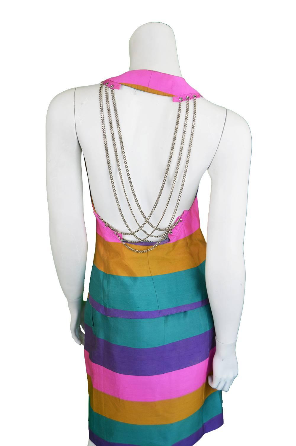 An incredible vintage womens two piece skirt suit from the 1990s by legendary French designer, Paco Rabanne. In an incredible rainbow striped silk dupion fabric with silver tone metal chains draping elegantly down the open back, creating the space