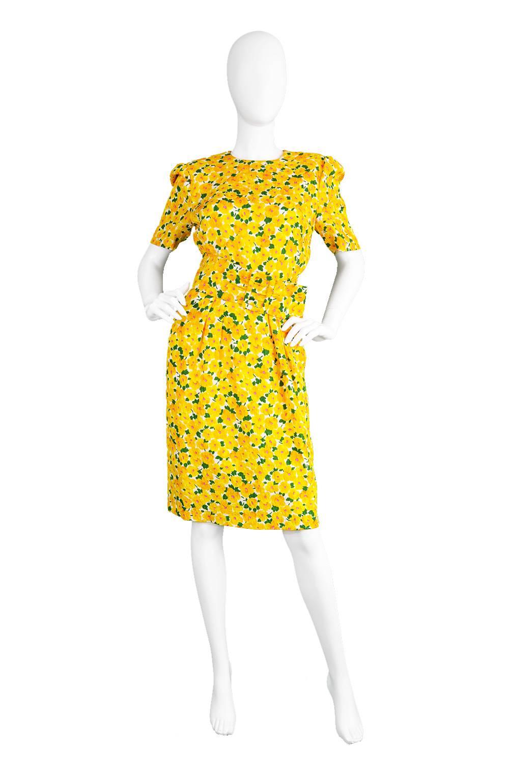 A fun and feminine number from the 1980s by British couturier and royal dressmaker, Hardy Amies. In a textured silk fabric with a bold, summery print throughout of yellow and orange watercolour daisies. Perfect for wearing to a countryside tea party