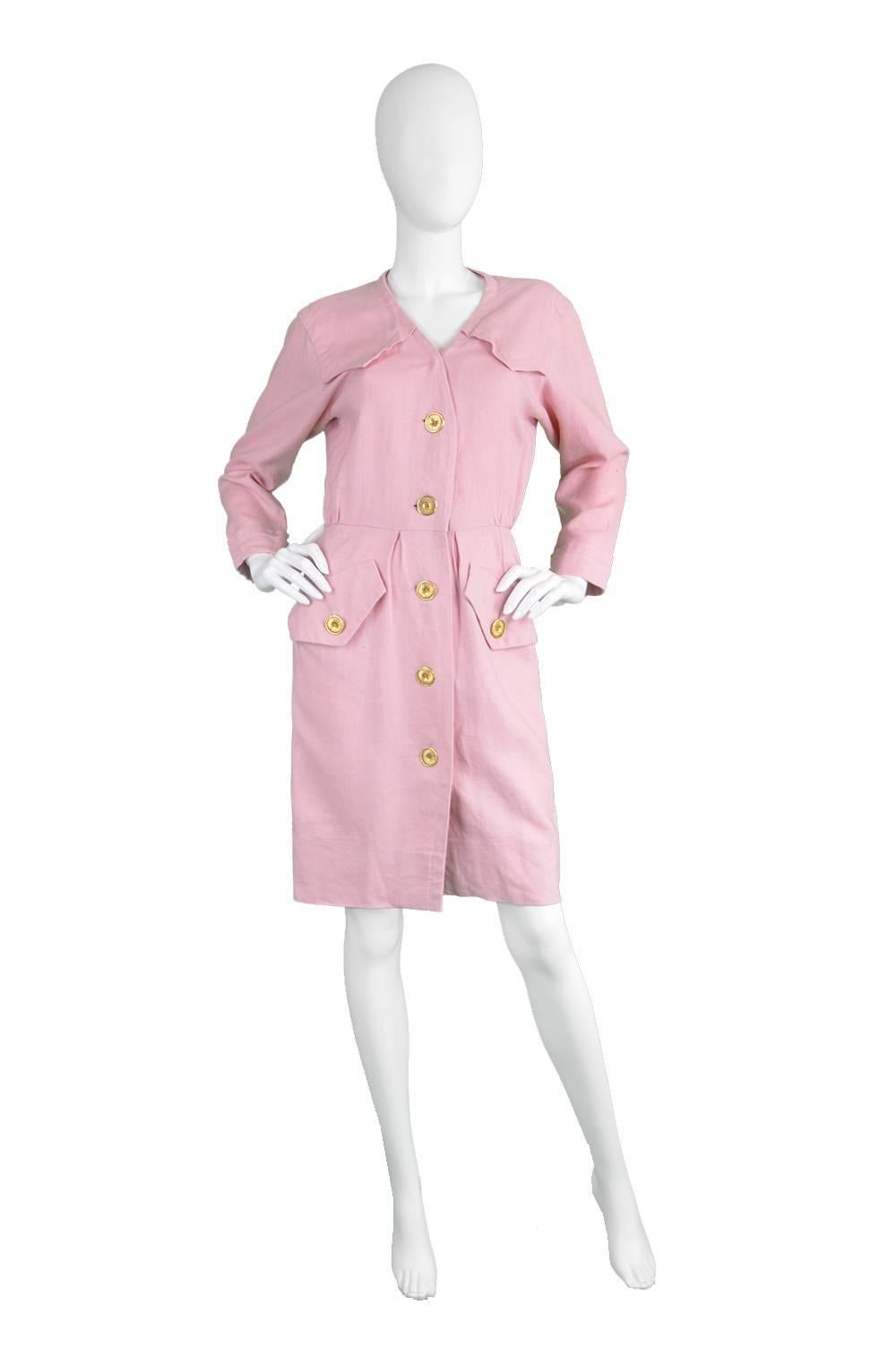 A chic and sophisticated vintage Yves Saint Laurent dress from the 1980s in a baby pink linen, which gives incredible structure and drape. With shoulder details that match the pockets, giving an almost safari style inspiration, but in a feminine