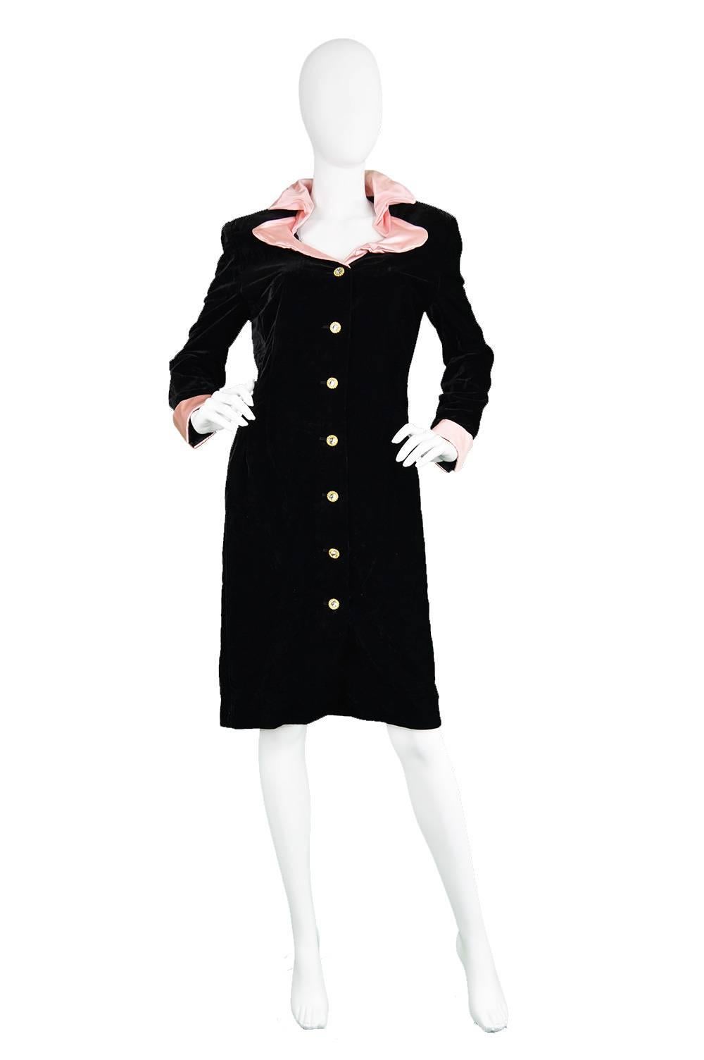 A striking and luxurious vintage coat dress from the 1980s by German luxury designer, Escada. In an inky black soft rayon velvet and the most incredible pink silk satin collar, which is wired so you can mould it and create avant garde architectural