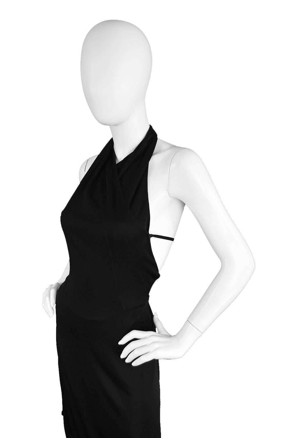 An incredibly sexy vintage little black dress from c. 1990s by master of dressing the feminine form, Azzedine Alaïa. In a rayon jersey knit which creates incredible drape and form, with his signature deep, scooped back all the way down with only