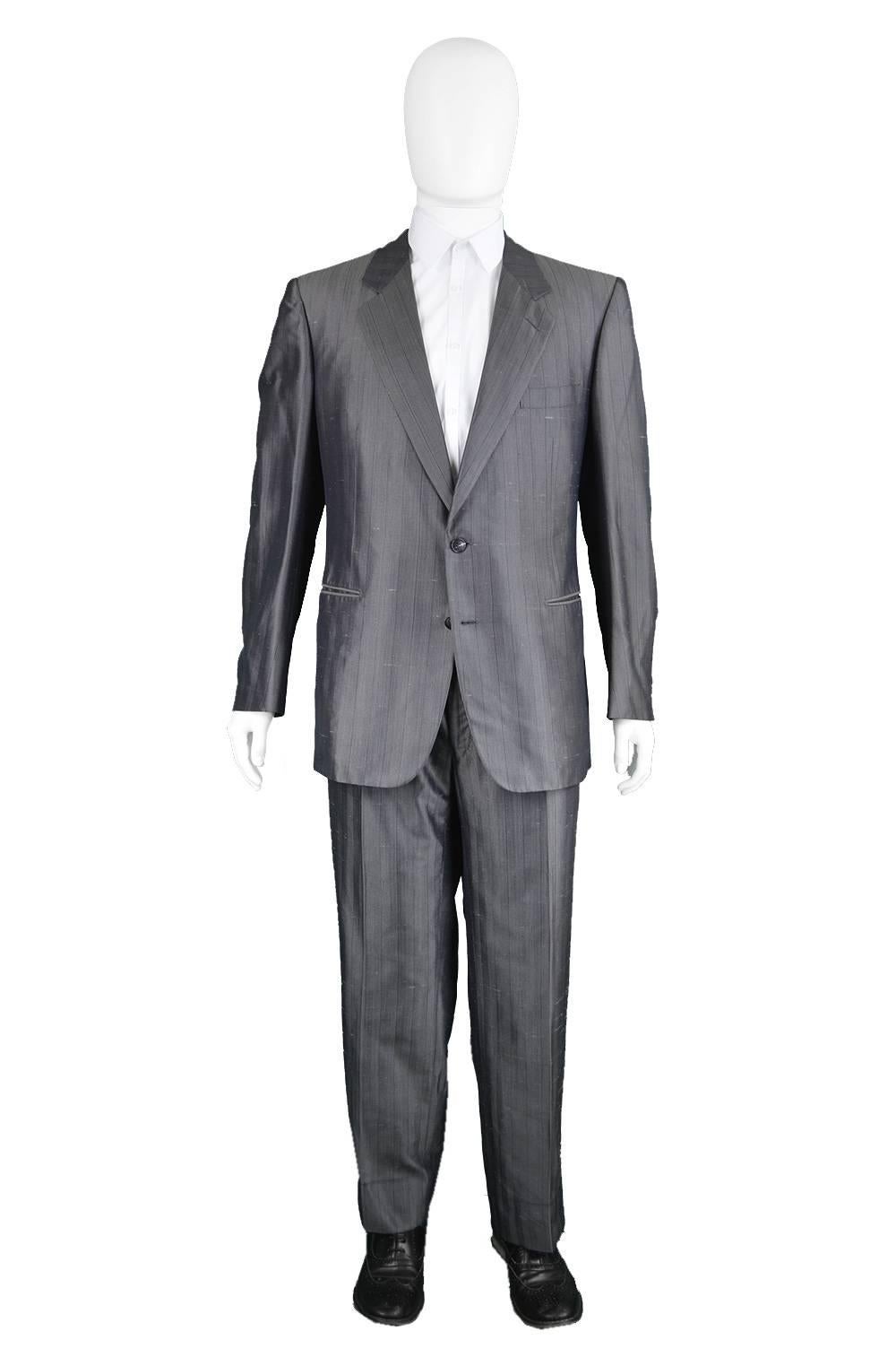 An incredibly luxurious vintage Christian Dior Monsieur Suit in a grey slub silk with incredible sheen  and pinstripes throughout. With narrow, notched lapels, welt pockets and single breasted buttons which create such a timeless look. Made in