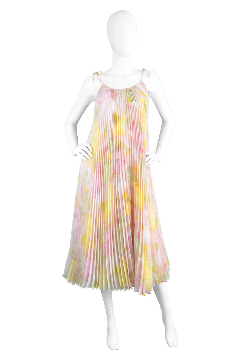 A breathtakingly beautiful vintage dress from the 1970s by highly collectible and genius designer, Yuki of London for Rembrandt. In yards of light, sheer chiffon fabric with a rainbow of pastel colours throughout all accordion pleated to perfection,