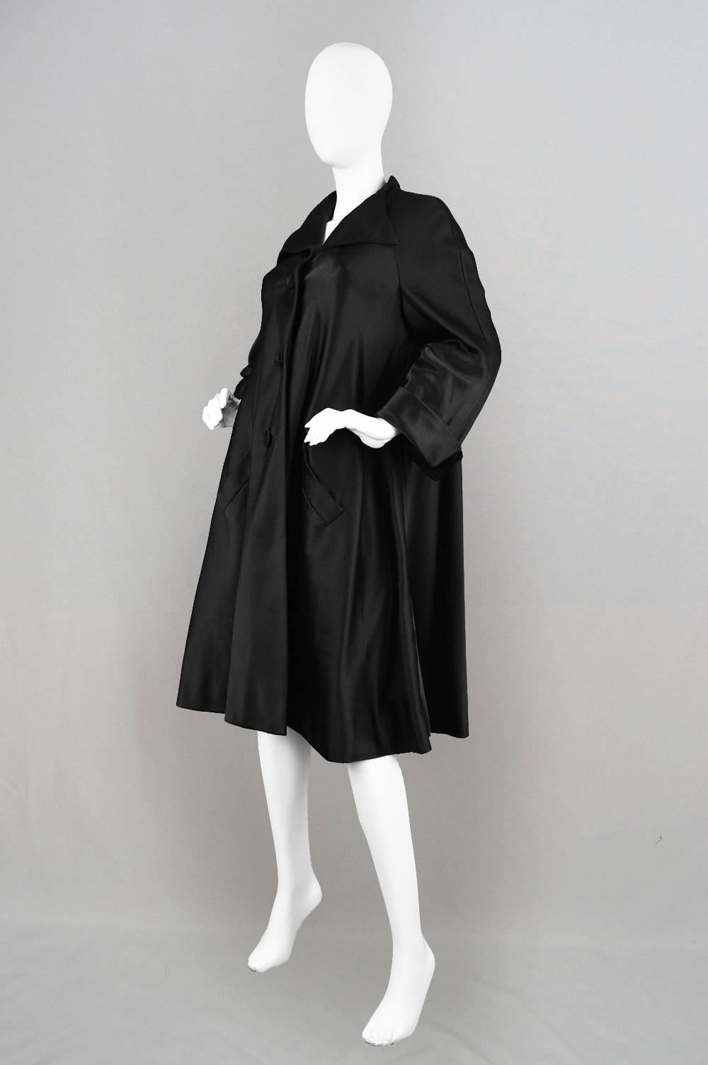 An incredibly elegant vintage evening coat by the British couturier, Hardy Amies.  With his couture label, this coat was constructed by hand to a couture standard in the Savile Row atelier. In a luxurious amount of silk satin fabric with an 120