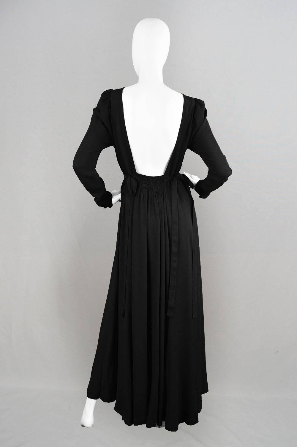 An absolutely breathtaking vintage Ossie Clark dress with the 'couture' Quorum label, from the 1970s. In his signature black moss crepe, which gives amazing drape and fluidity, this is an incredibly rare and collectible Ossie Clark piece and would