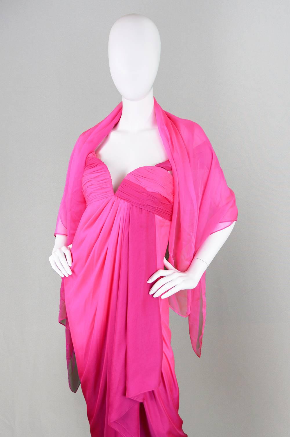 An absolutely breathtaking vintage dress from the 1980s by Andrea Odicini for his couture line. Truly the perfect fit for a red carpet or the most elegant evening event, the layers of hot pink silk chiffon swathe around the feminine form like a