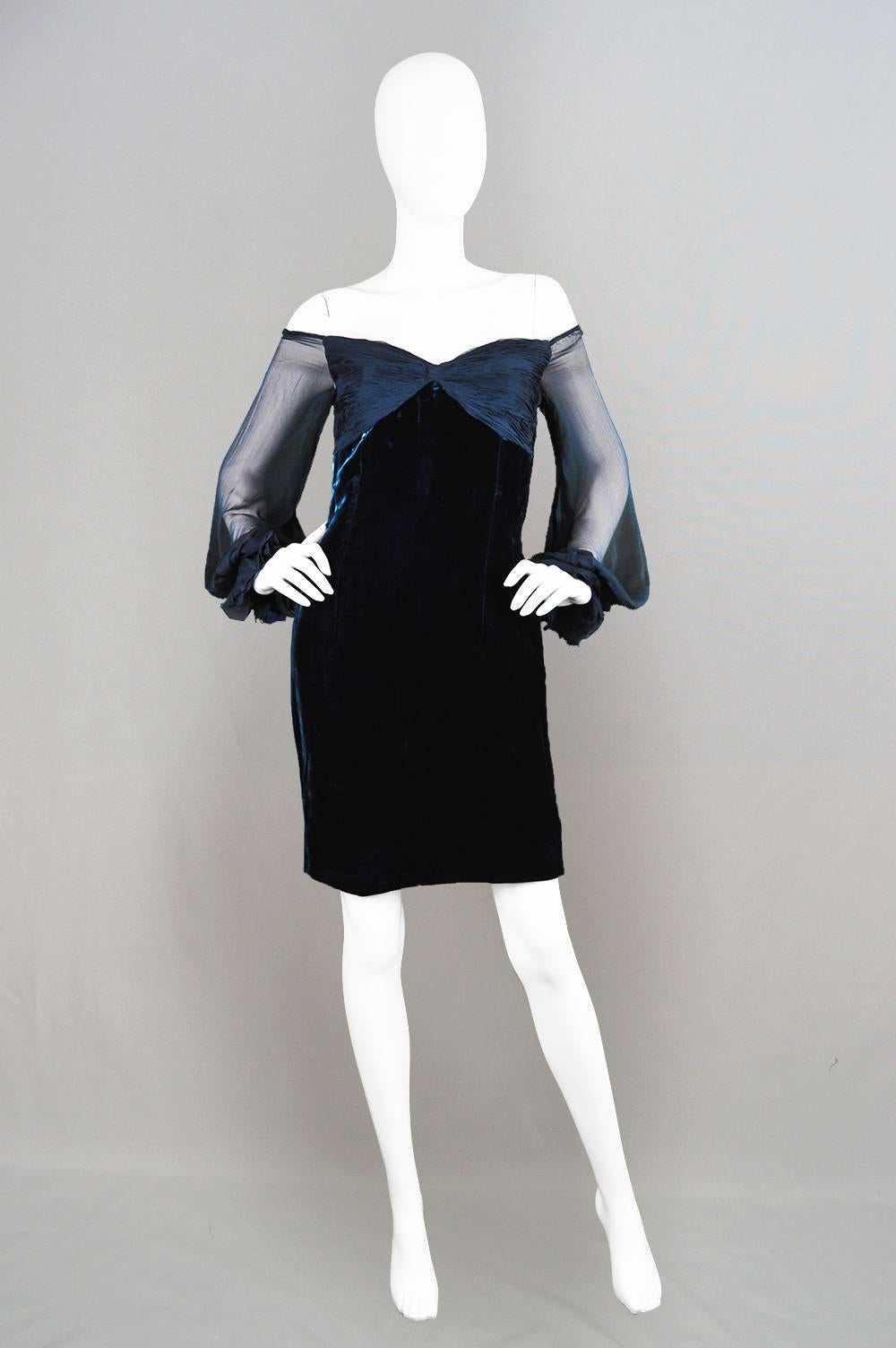 A stunning vintage party dress by Valentino for their boutique line, from the A/W 1991 collection. In a silky blue velvet with a ruched bust and sheer silk chiffon off the shoulder sleeves, creating a glamorous look with loads of sex appeal.