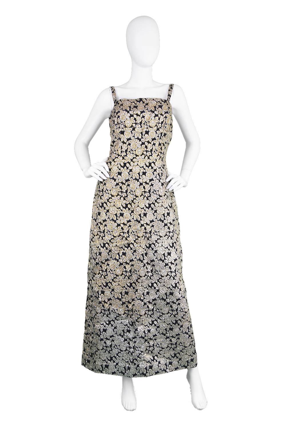 An elegant and sophisticated vintage dress and jacket two piece set from the 1960's by luxury British vintage designer, Frederick Starke for iconic high-end department store - Harrods. In a gold and silver floral lamé brocade set against a black