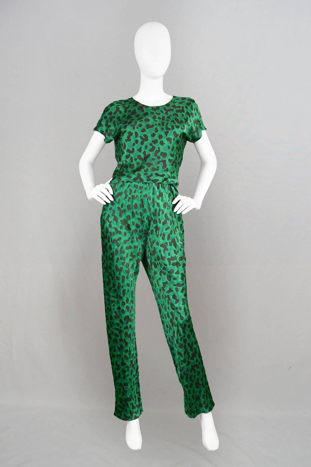 A chic and luxurious vintage two piece pant suit from the 1990s by Celine of Paris. With an abstract pattern, almost reminiscent of camouflage or animal print, printed onto a light, pure green silk which has such great fluidity, airiness and