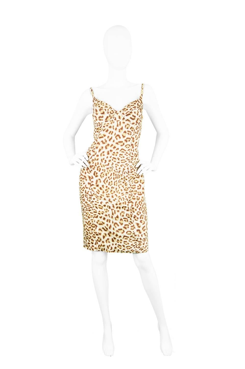A chic and sexy vintage wiggle dress from the 1980s from luxury designer label, Escada by Margaretha Ley. With a sculpted, built-in bra which creates a sensual, feminine silhouette. The straps have signature gold-tone 'E' hardware which add a