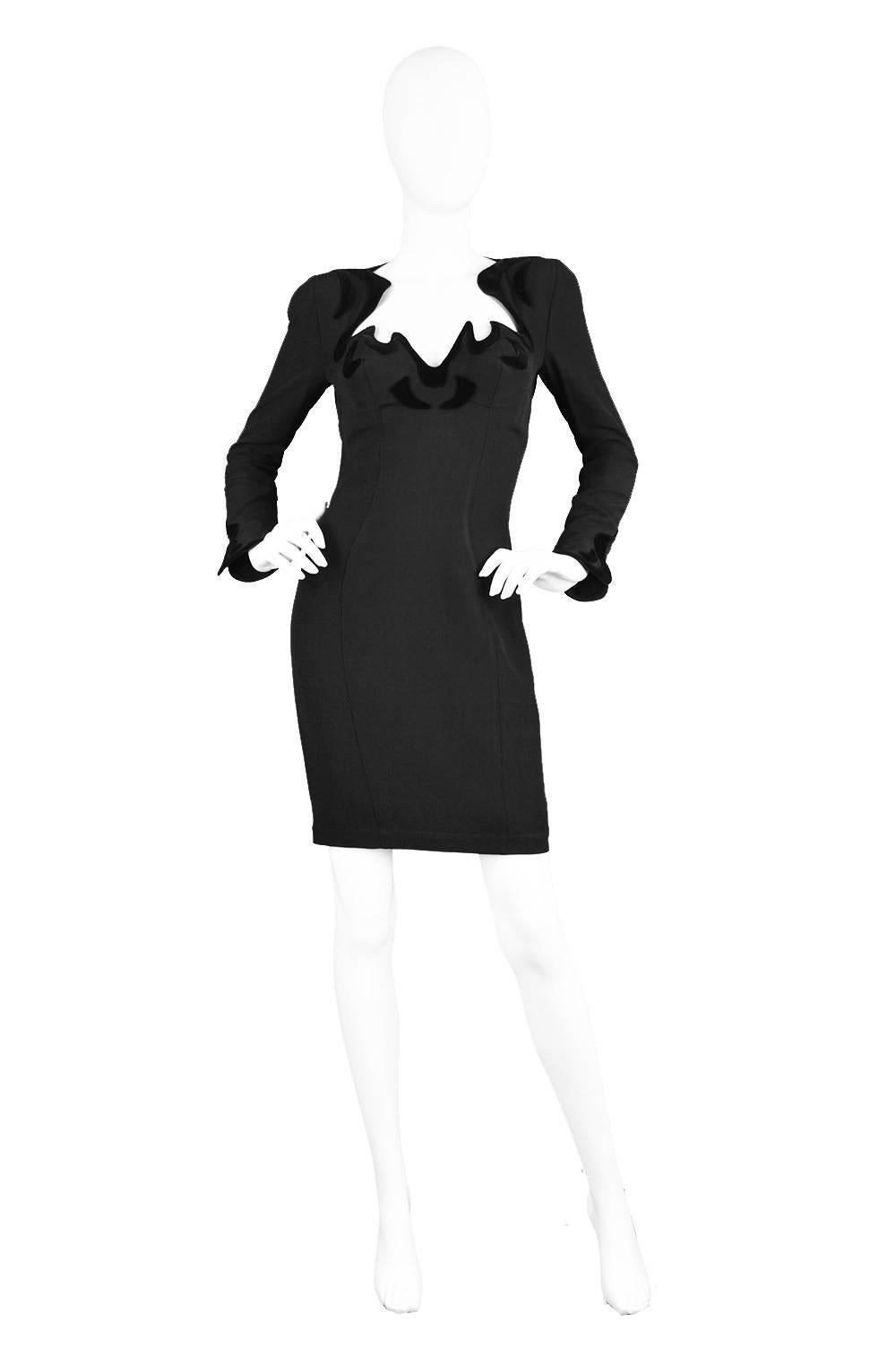 A stunning vintage Thierry Mugler dress  from the early 90s in a light crepe fabric with a flocked velvet around the cuffs and the sexy, dramatic neckline - which is supported by a built in bra. The shoulder pads give an edgy look, with loads of sex