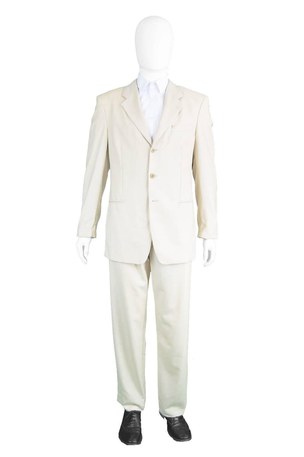 An absolutely incredible men's vintage two piece suit from the early 1990s by legendary Italian designer, Gianni Versace for his couture line. In a cream fabric with a subtle medusa head jacquard weave throughout, not noticeable until someone gets