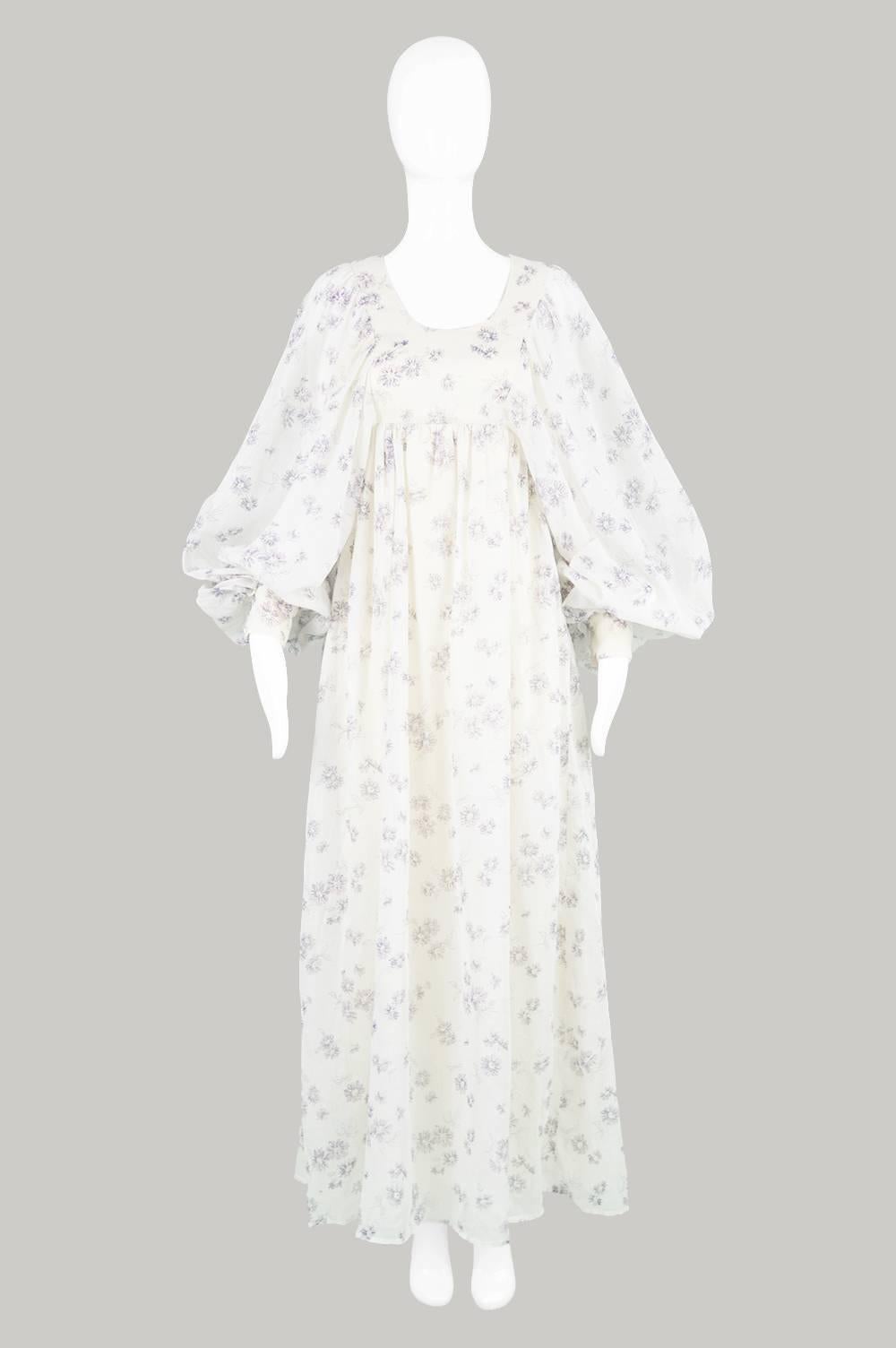 An absolute dream of a vintage bohemian dress, by British boutique label, Fiona Dresses. This breathaking gown is in a delicately floral printed, flowing, cotton voile with some of the biggest, most diaphanous balloon sleeves we've ever seen on a
