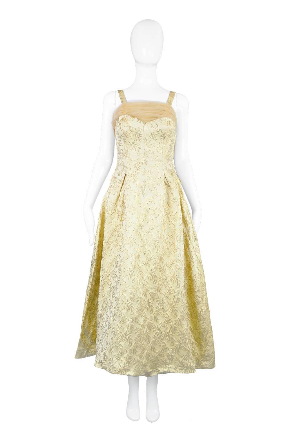 A glamorous vintage evening dress from the 50s with a ruched chiffon shelf bust and matching train to the rear. In a luxurious gold silk and lame brocade by Lee Delman.

Estimated Size: UK 8-10 / US 4-6/ EU 36-38
Bust - 32