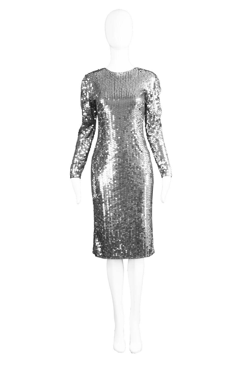 A glamorous vintage Halston party dress from the 1970s with silver sequins on a jersey fabric and a deep scoop back

Estimated Size: UK 10/ US 6/ EU 38
Bust - 34” / 86cm
Waist - 28” / 71cm
Hips - 36” / 91cm
Length (Shoulder to Hem) - 41” /