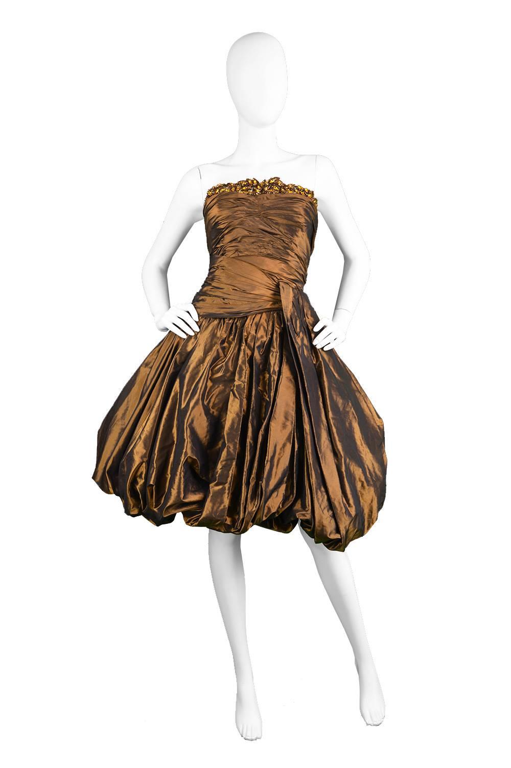 A luxurious and elegant vintage Jean Louis Scherrer couture dress from the 1980s in a bronze silk taffeta.

Estimated Size: UK 8/ US 4/ EU 36 
Bust - 32” / 81cm
Waist - 26” / 66cm
Hips - up to 36” / 91cm

This glamorous evening dress is in a