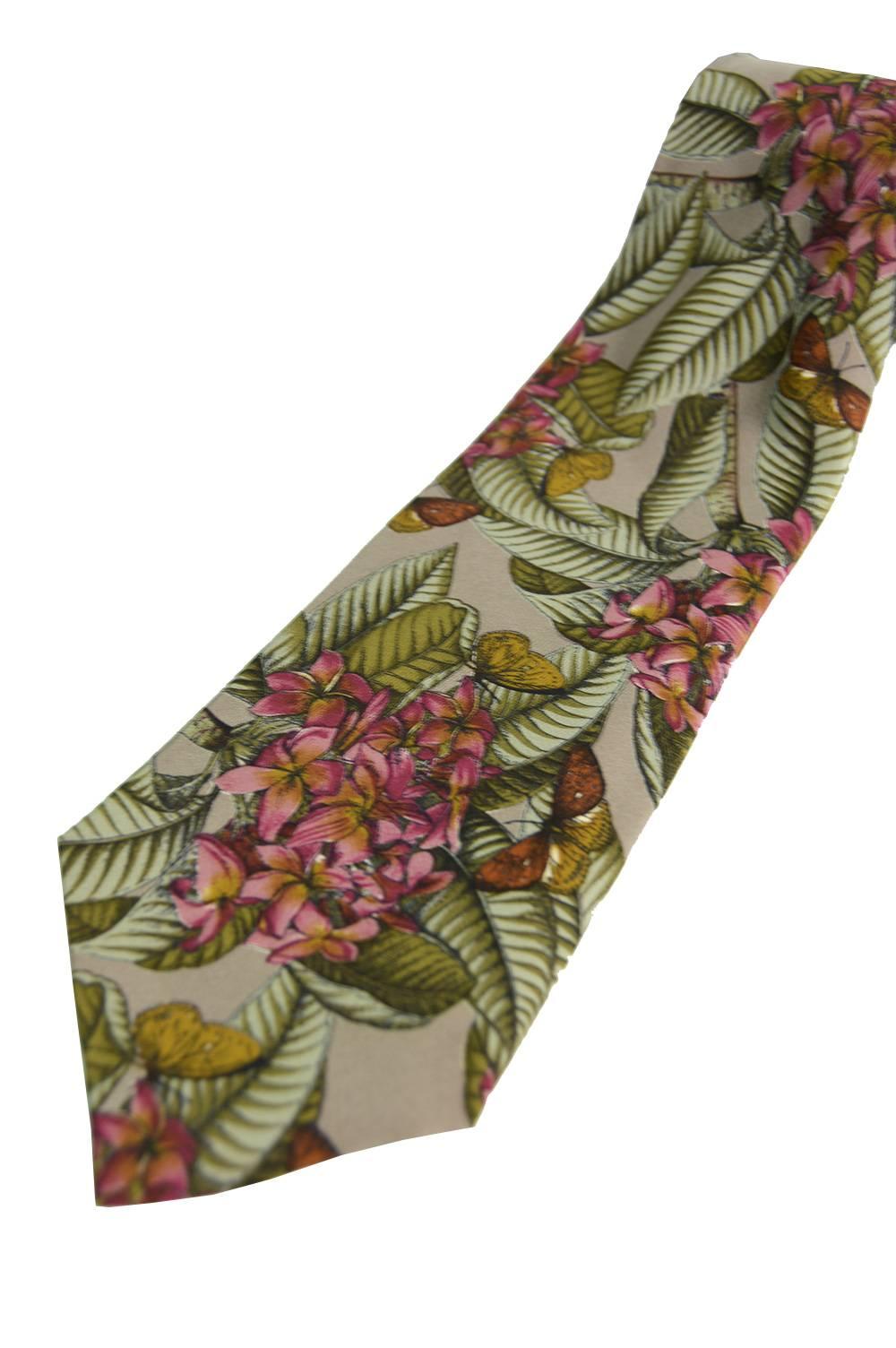 An elegant vintage mens necktie in a pure silk by French designer, Yves Saint Laurent. Looks so current, fitting with 70s trends whilst still being stylish and classic, it would make the perfect gift for him. With a floral and butterfly print